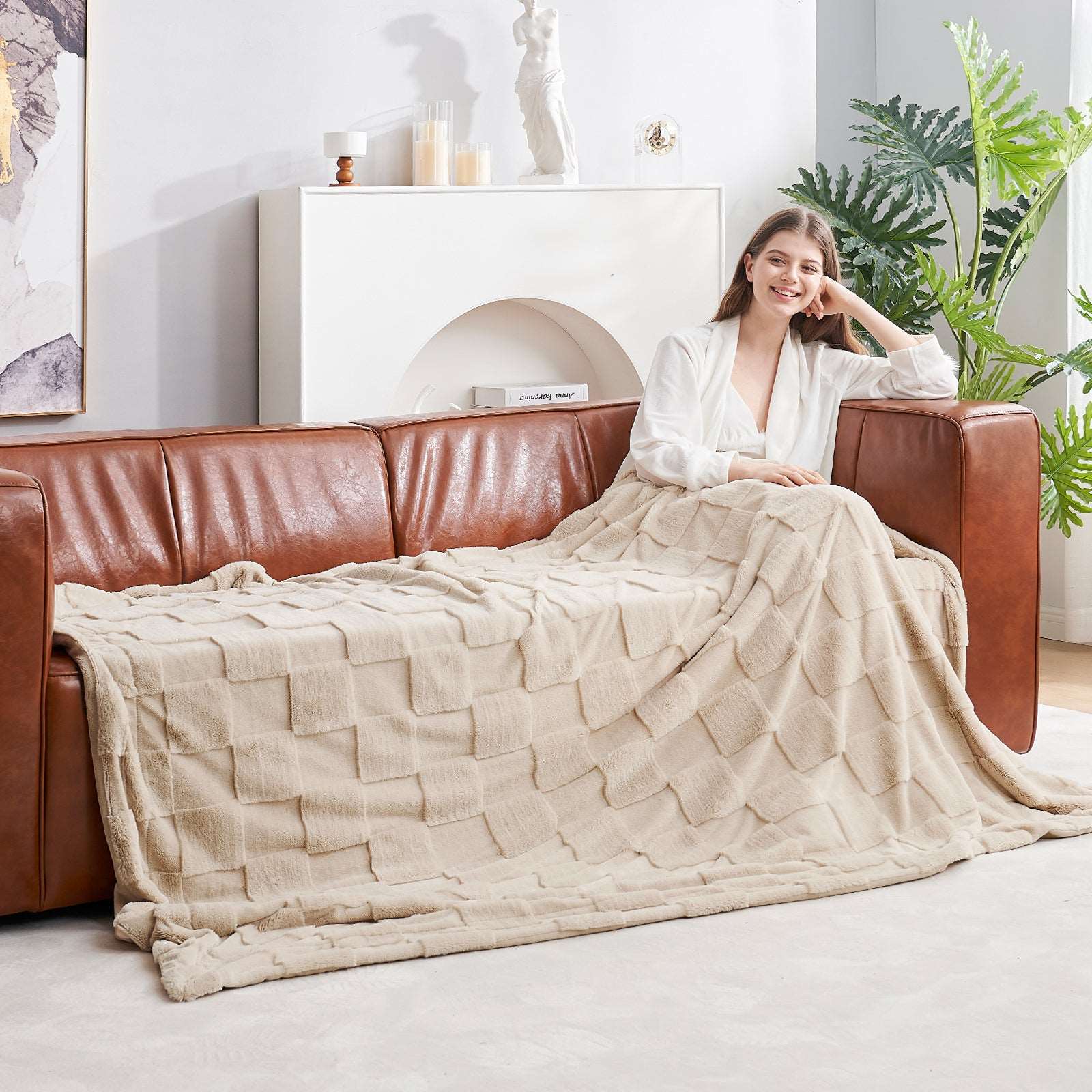 Woman with Cozy Bliss checkboard faux fur blanket on sofa #color_Beige