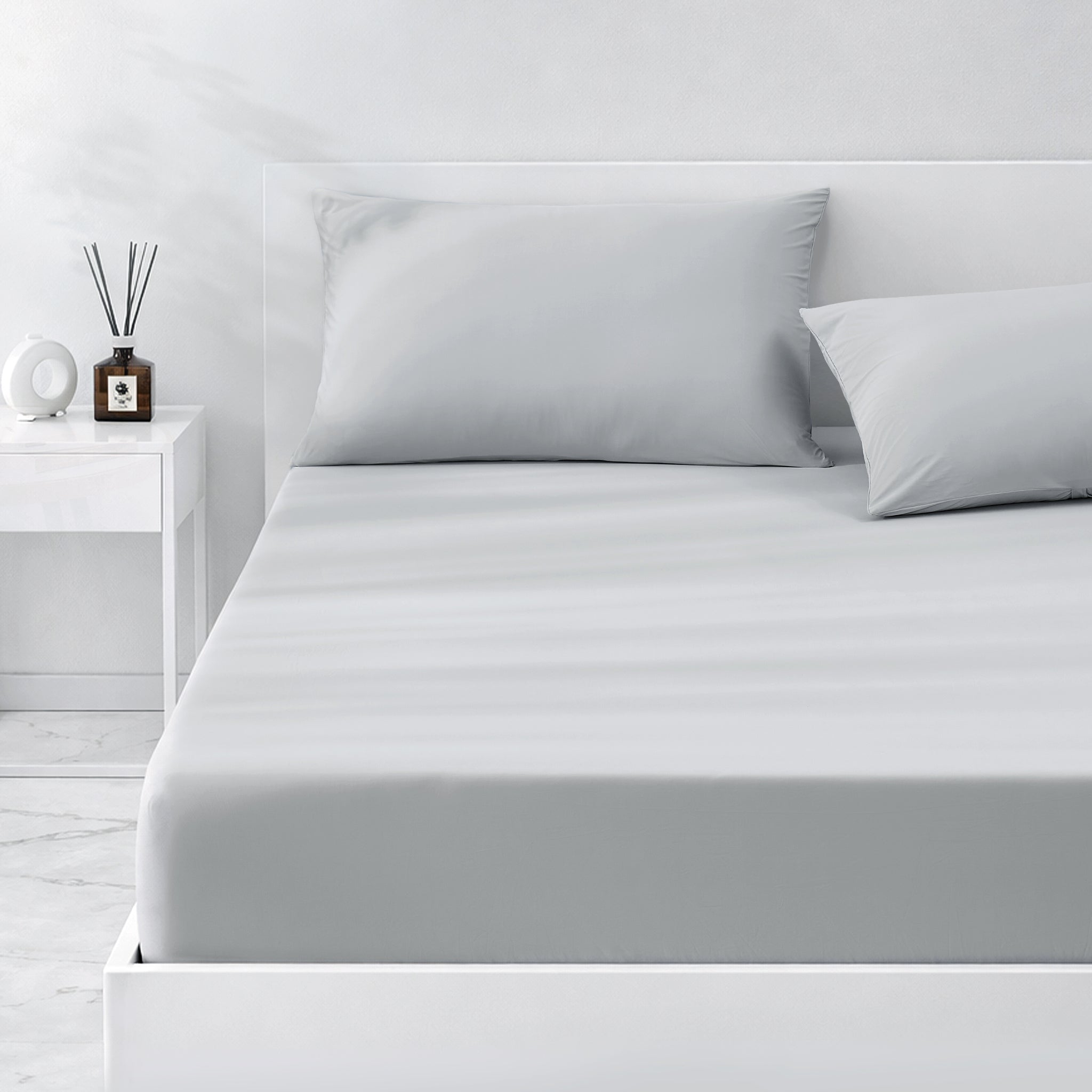 Gray cooling bedding set on a bed in a minimalistic bedroom setting.#color_Cool Grey