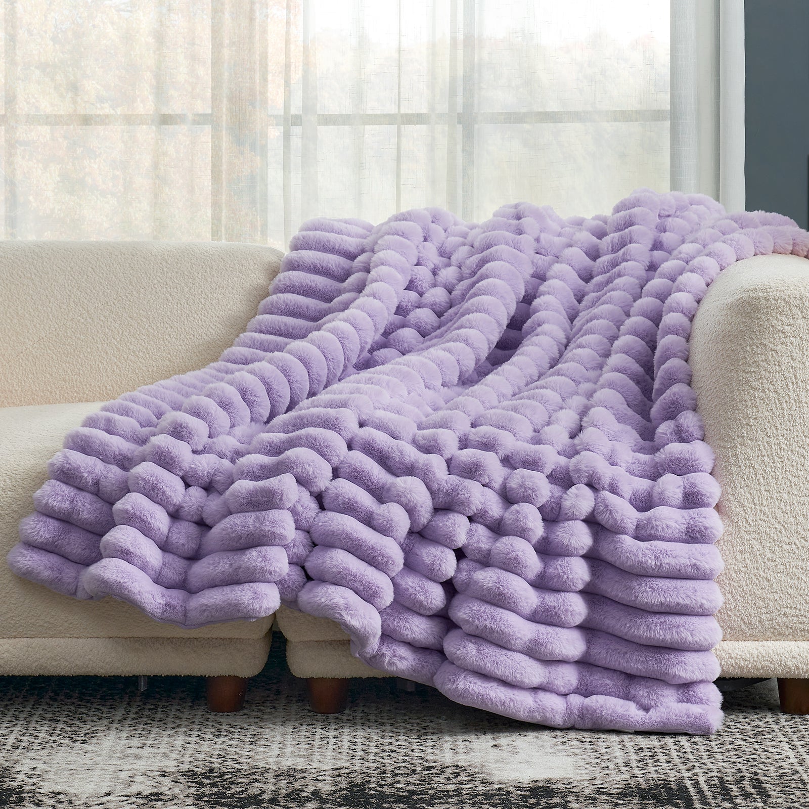 Cozy Bliss lavender striped faux fur throw blanket draped over a sofa, soft and cozy #color_Lavender Purple