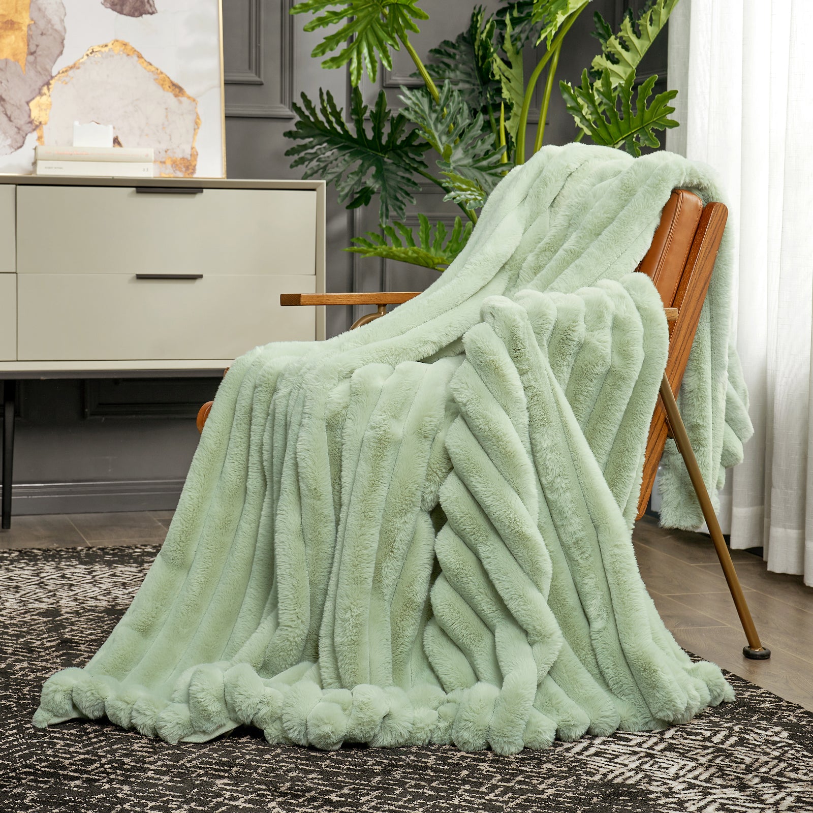 Sage green striped faux fur throw blanket draped over a chair. Cozy bedding for comfortable relaxation. #color_Sage Green