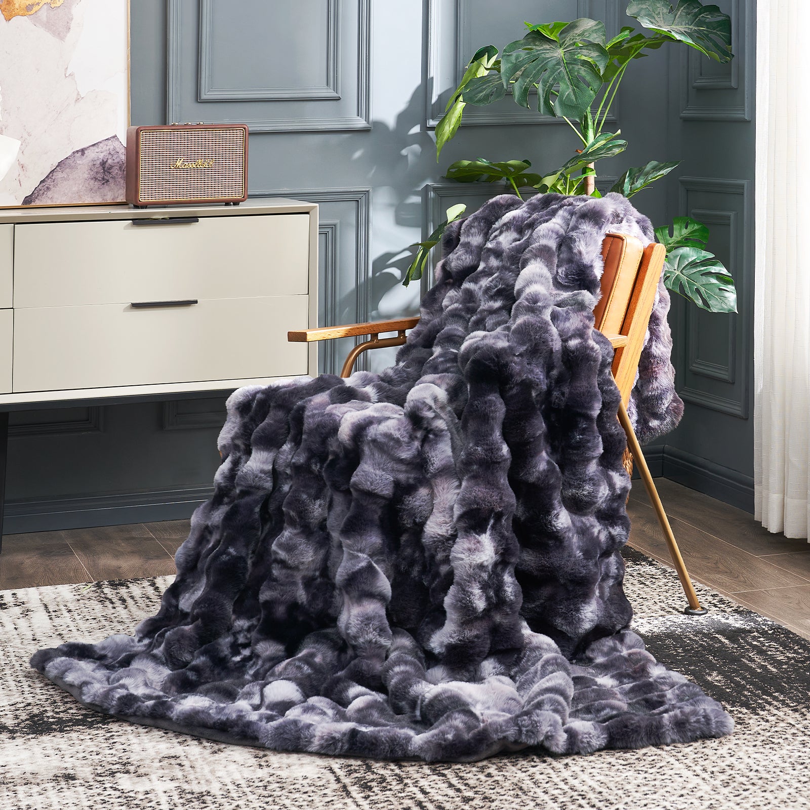 Cozy Bliss tie-dye black faux fur throw blanket on a chair, a cozy blanket. #color_Tie-dye Black