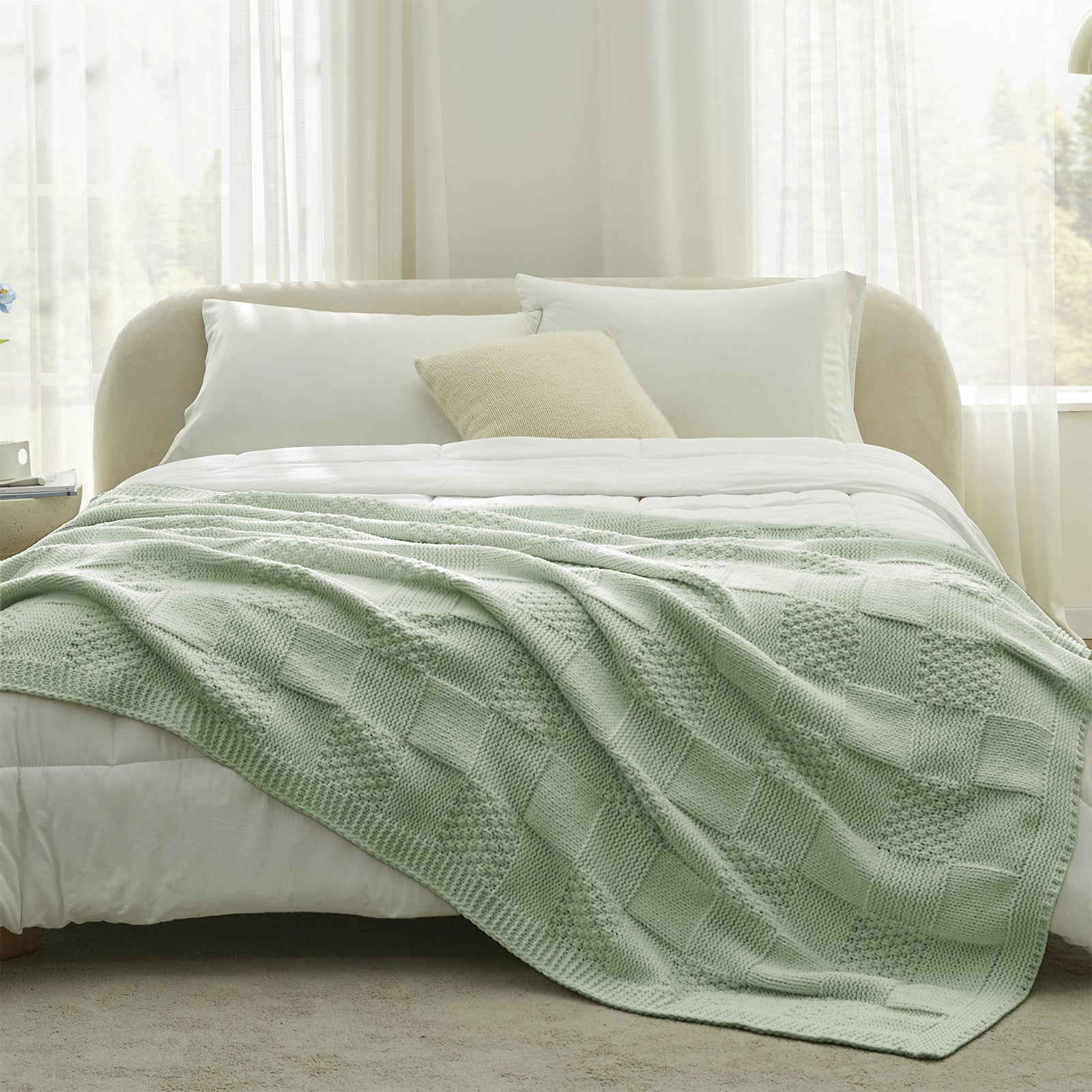 Sage Green blanket on a bed in a bright bedroom with white bedding and curtains. #color_Sage Green