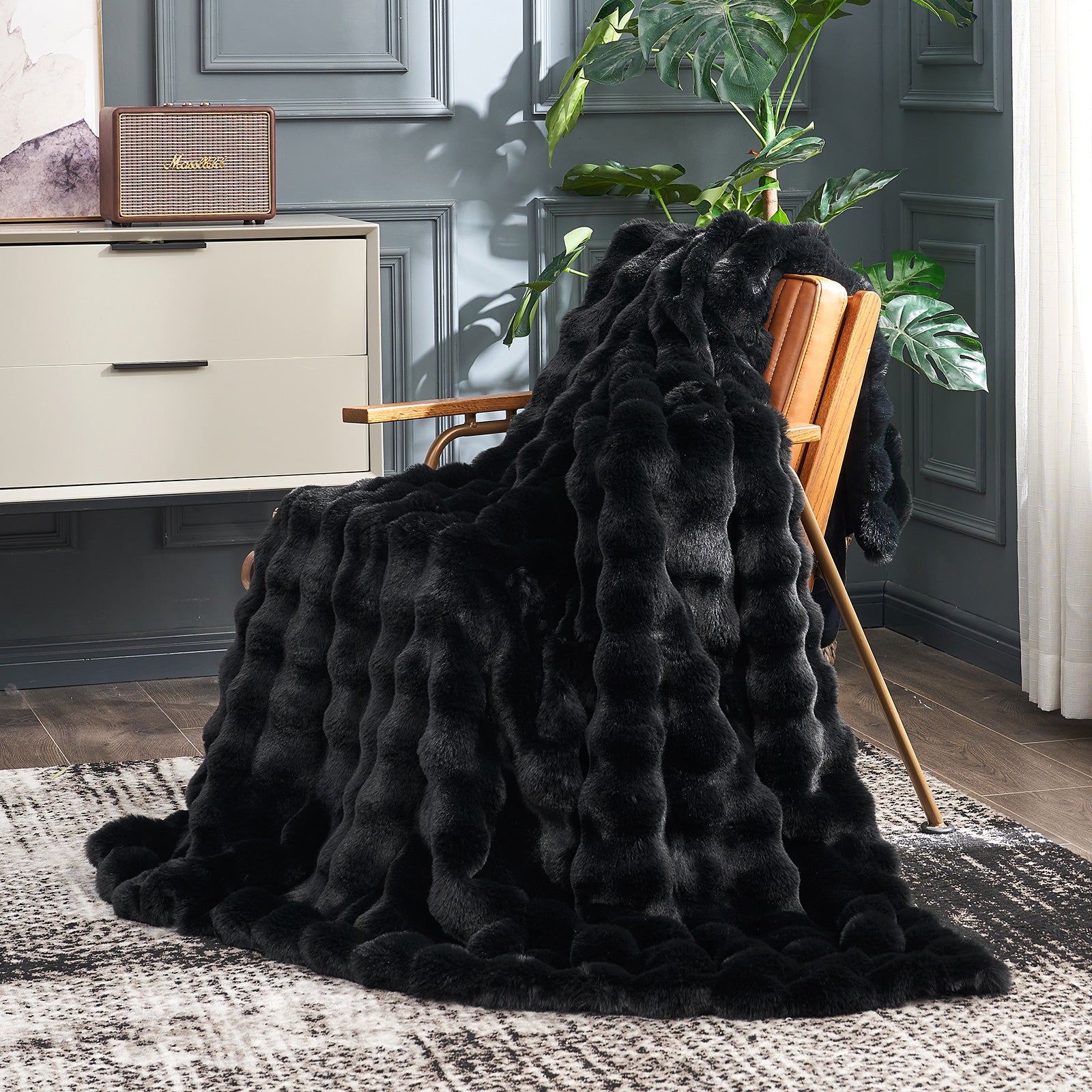 Black faux fur blanket draped over a wooden chair, a cozy blanket for a comfortable space #color_Black