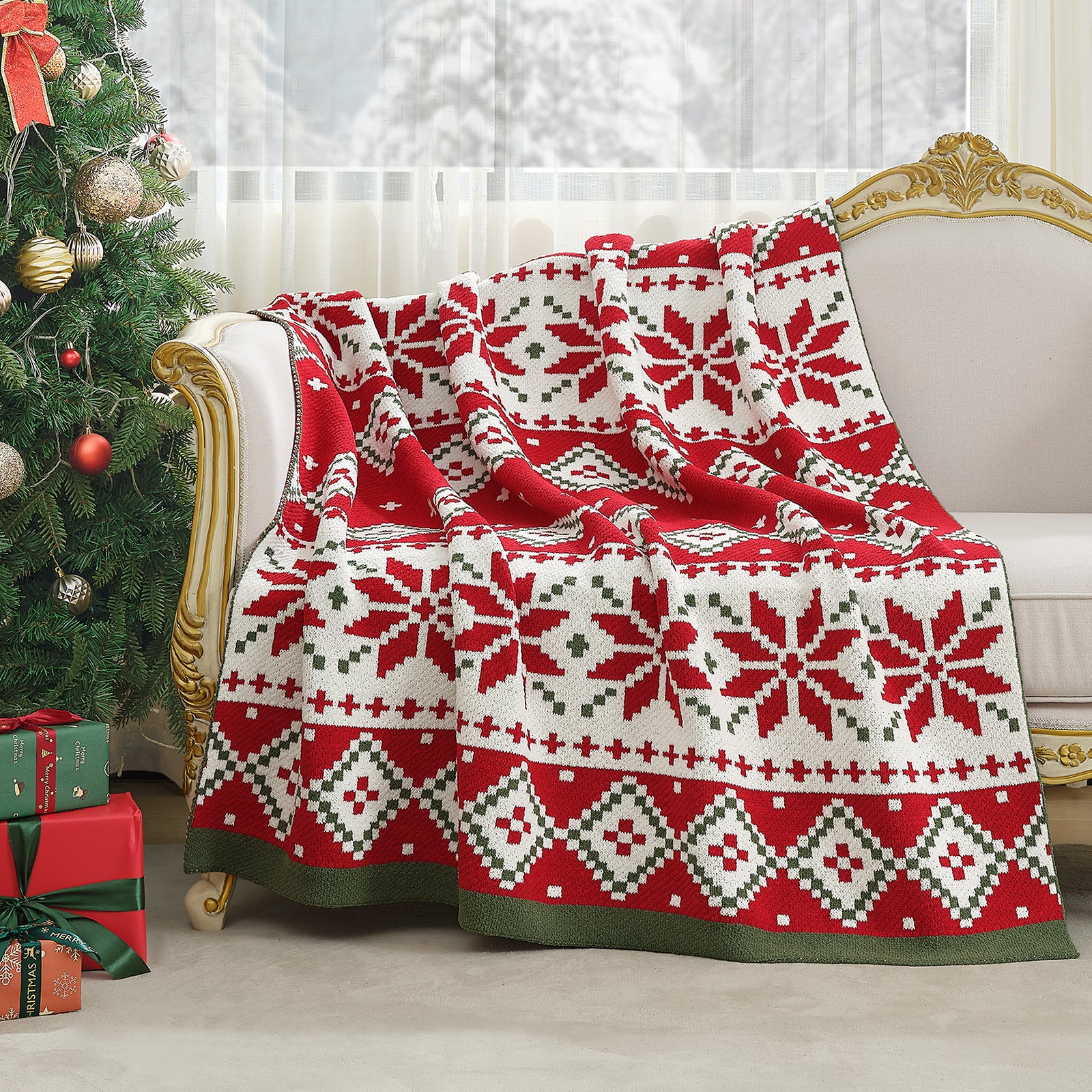 Red and white patterned blanket draped over a sofa in a festive living room with Christmas tree and presents. #color_Fair Isle