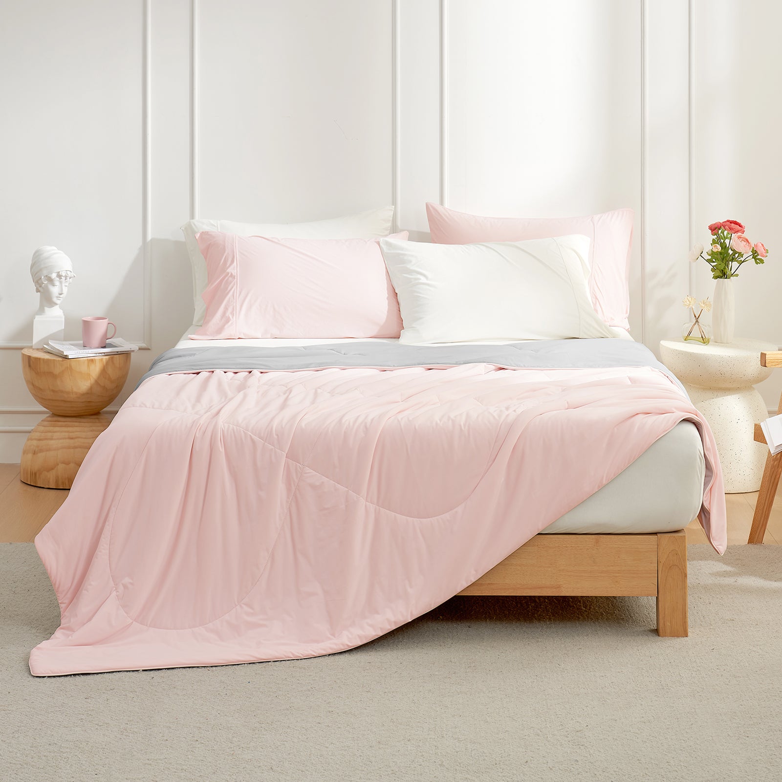 Cozy Bliss pink cooling comforter on bed, breathable bedding for hot sleepers, with pillows #Color_Pink/Grey