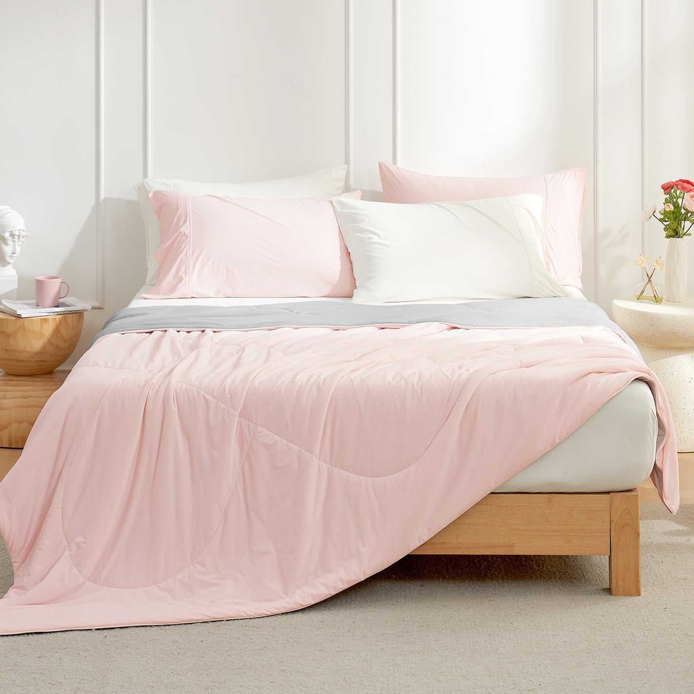 Cozy Bliss pink cooling comforter on bed, breathable bedding for hot sleepers, with pillows #Color_Pink/Grey