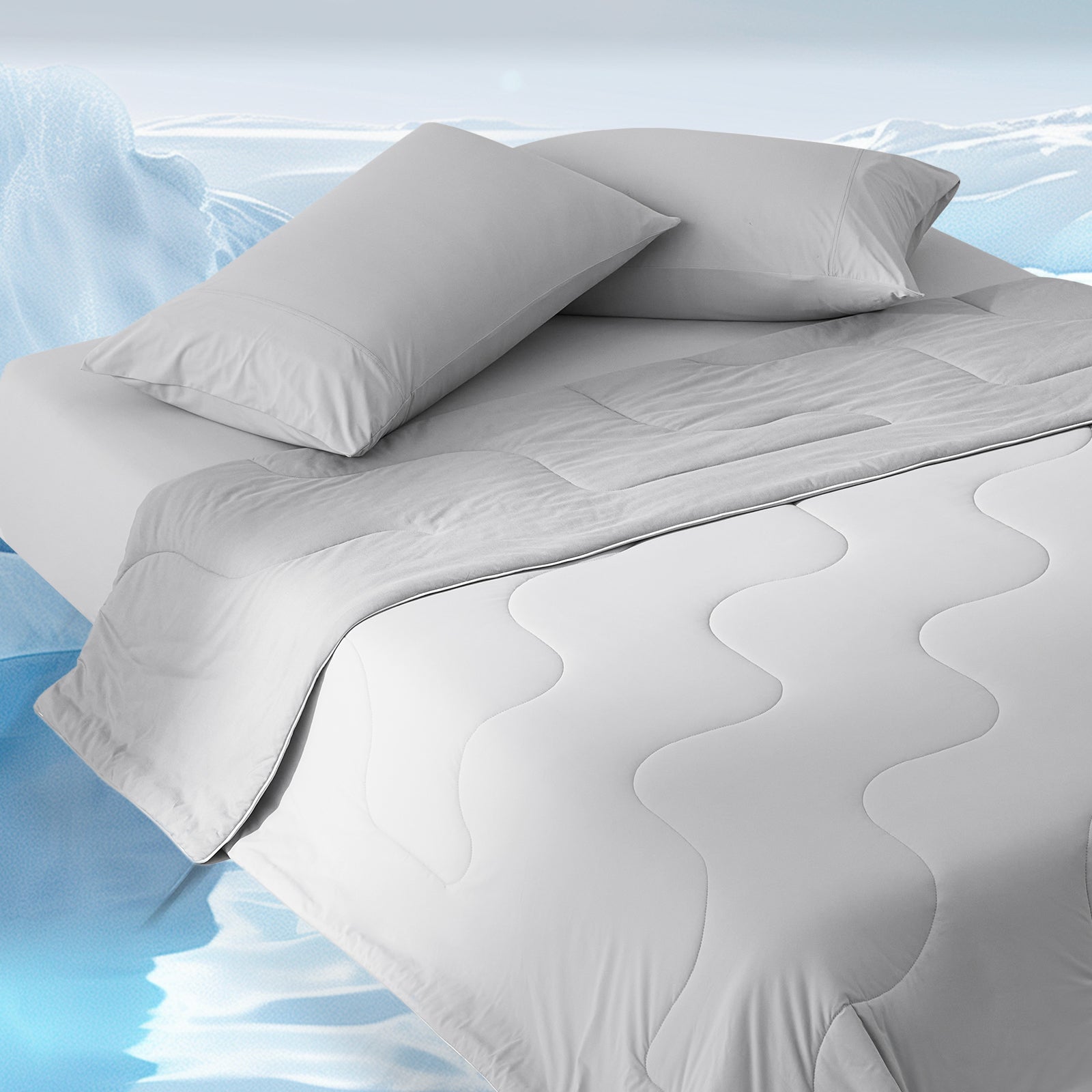 Gray cooling comforter on bed, offering cool, breathable sleep for hot sleepers. Cozy bedding design. #color_Cool Grey