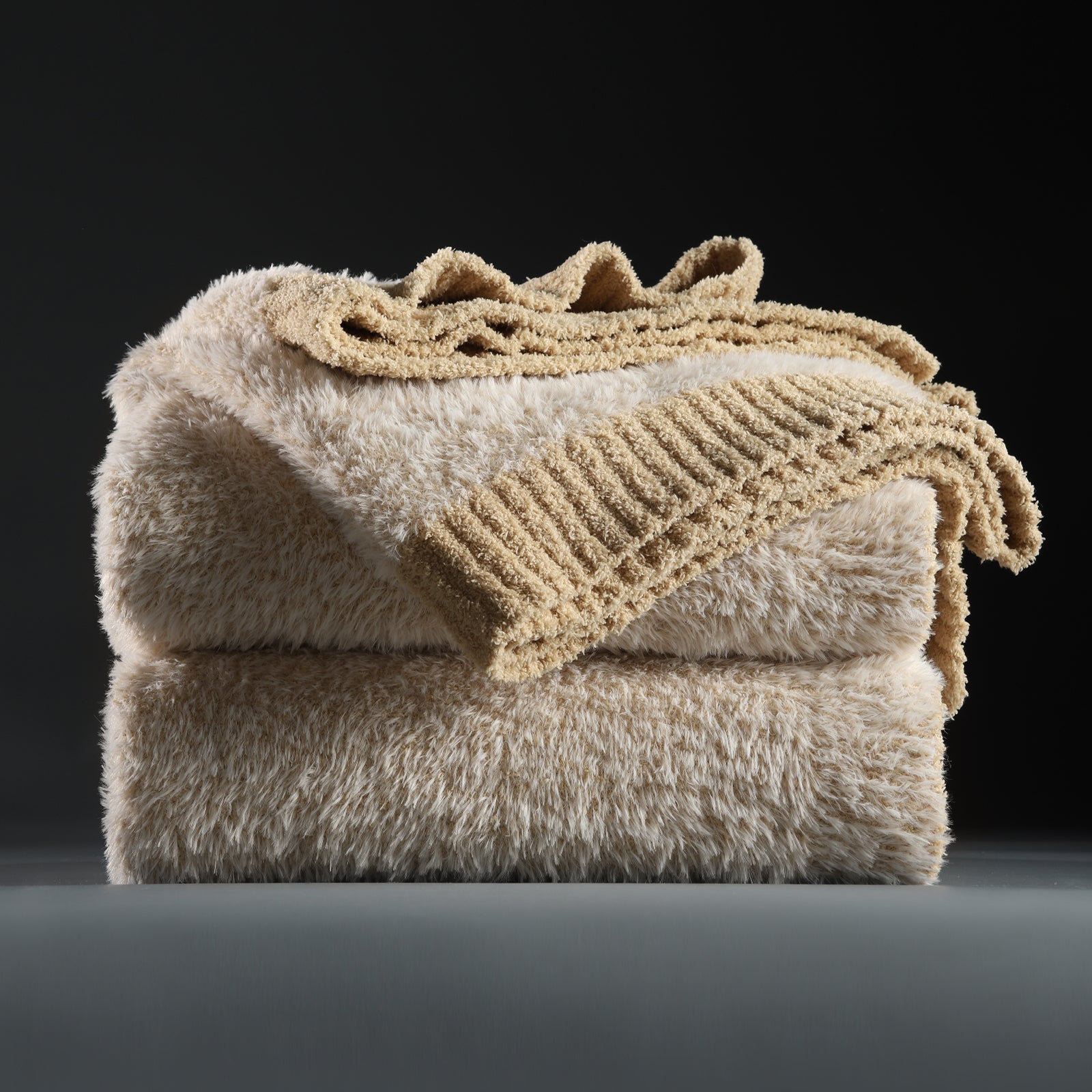 Faux Mink Feather Knit Throw Blanket in Beige neatly folded stack, showcasing soft feather yarn and premium texture. #color_Beige