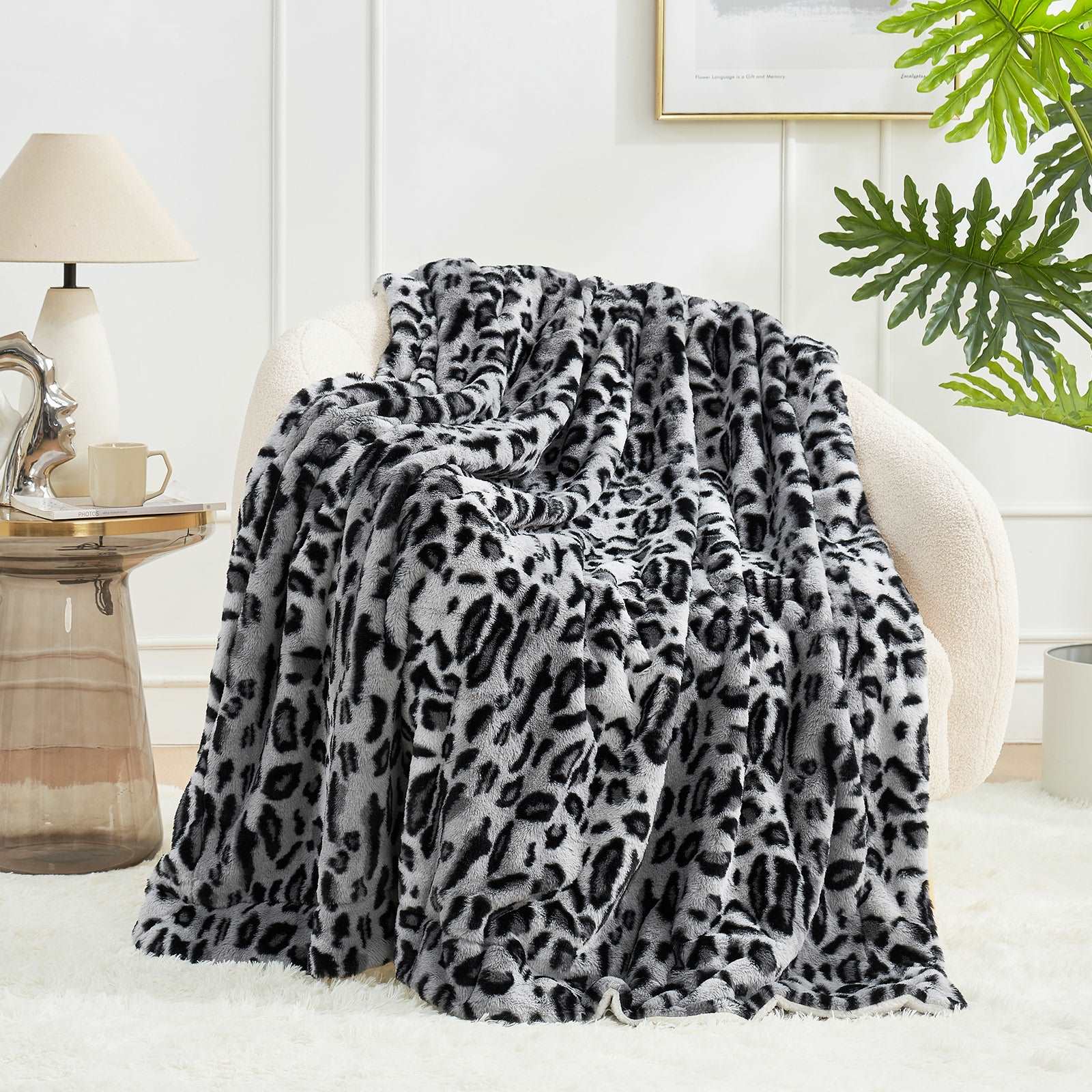 Gray and black leopard print faux fur blanket on an armchair #color_Snow Leopard