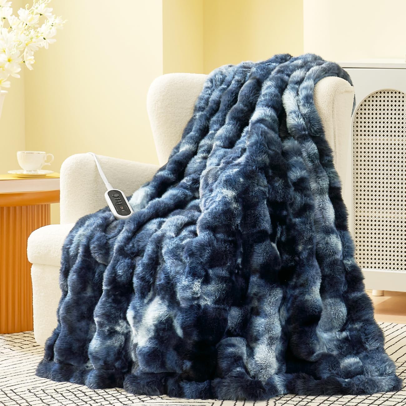 Blue heated blanket draped over a chair in a cozy living room. #color_Tie-dye Blue
