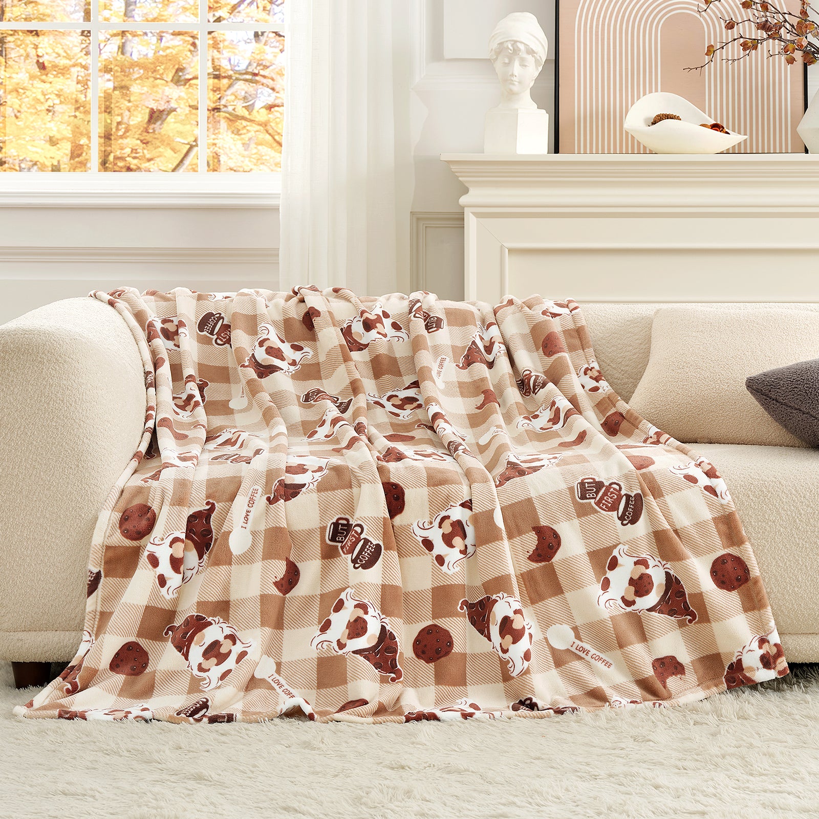 Floral-patterned throw blanket draped over a sofa in a living room.#color_Coffee Gnome Brown