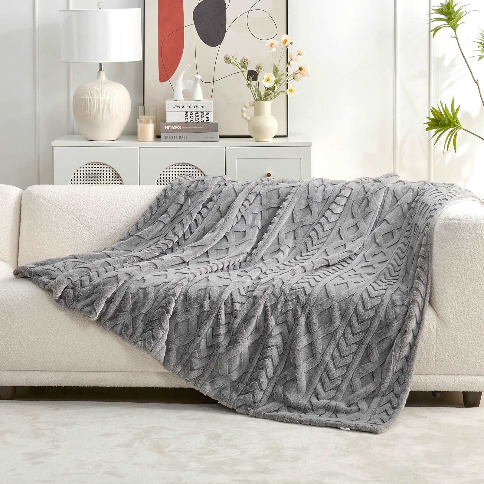 Gray cable knit faux fur throw blanket on white sofa #color_Grey