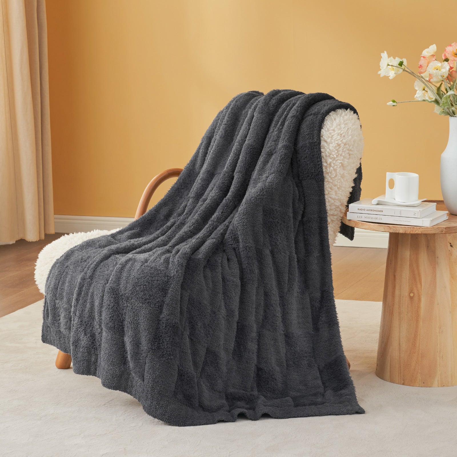 Checkered Faux Fur Feather Yarn Throw Blanket in Dark Grey draped over an armchair, adding a modern cozy feel. #color_Dark Grey