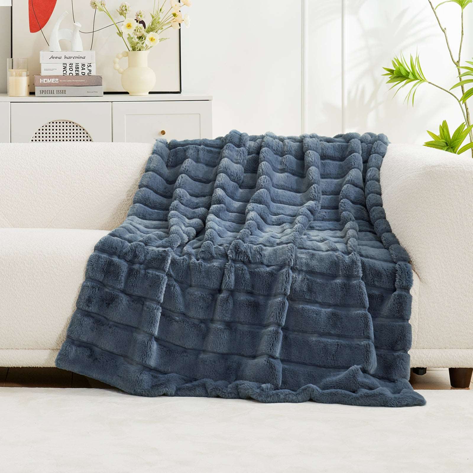 Blue Faux Fur Throw Blanket on white sofa, perfect for cozy living, enhancing bedroom aesthetics and comfort. #color_Blue