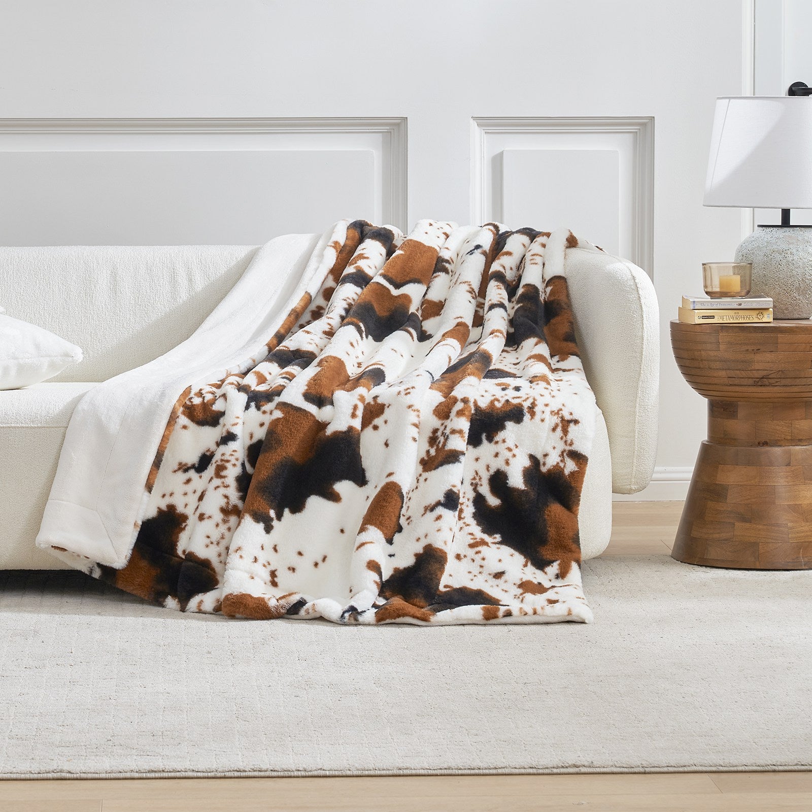 Cow print faux fur throw blanket on white sofa, cozy bedding and home decor #color_Black/Brown