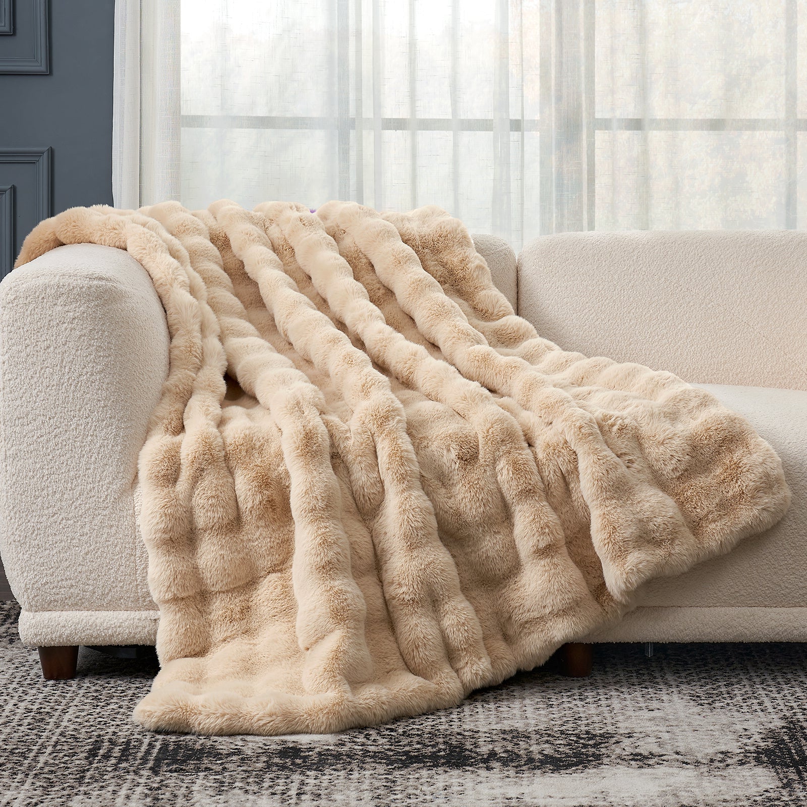 Cozy Bliss beige faux fur throw blanket on a sofa, soft, cozy blanket for comfort #color_Beige
