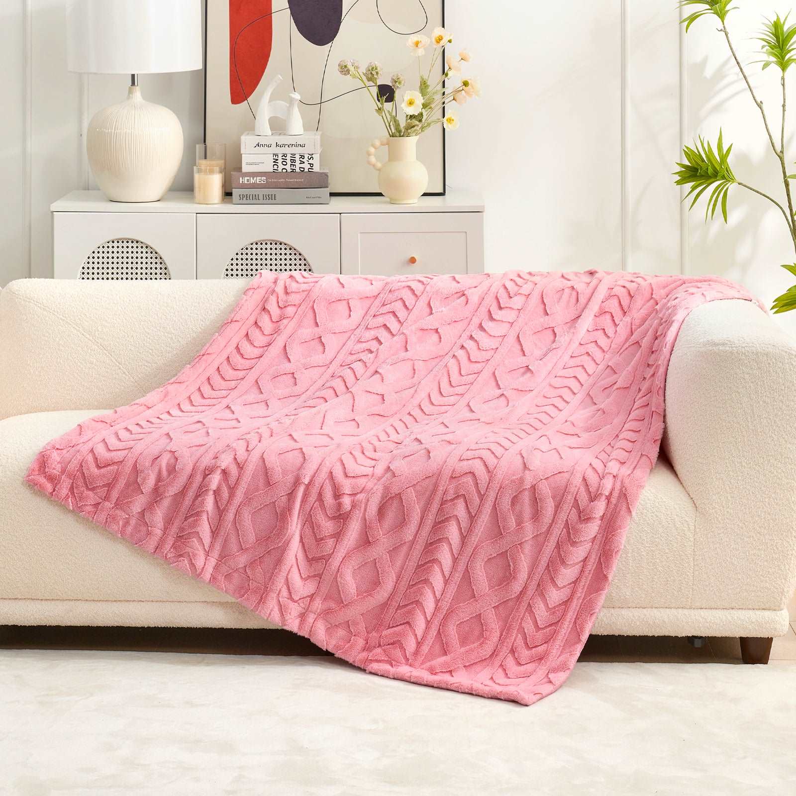 Pink cable knit faux fur blanket on sofa. Cozy home decor with soft, breathable throw blanket. #color_Hot Pink
