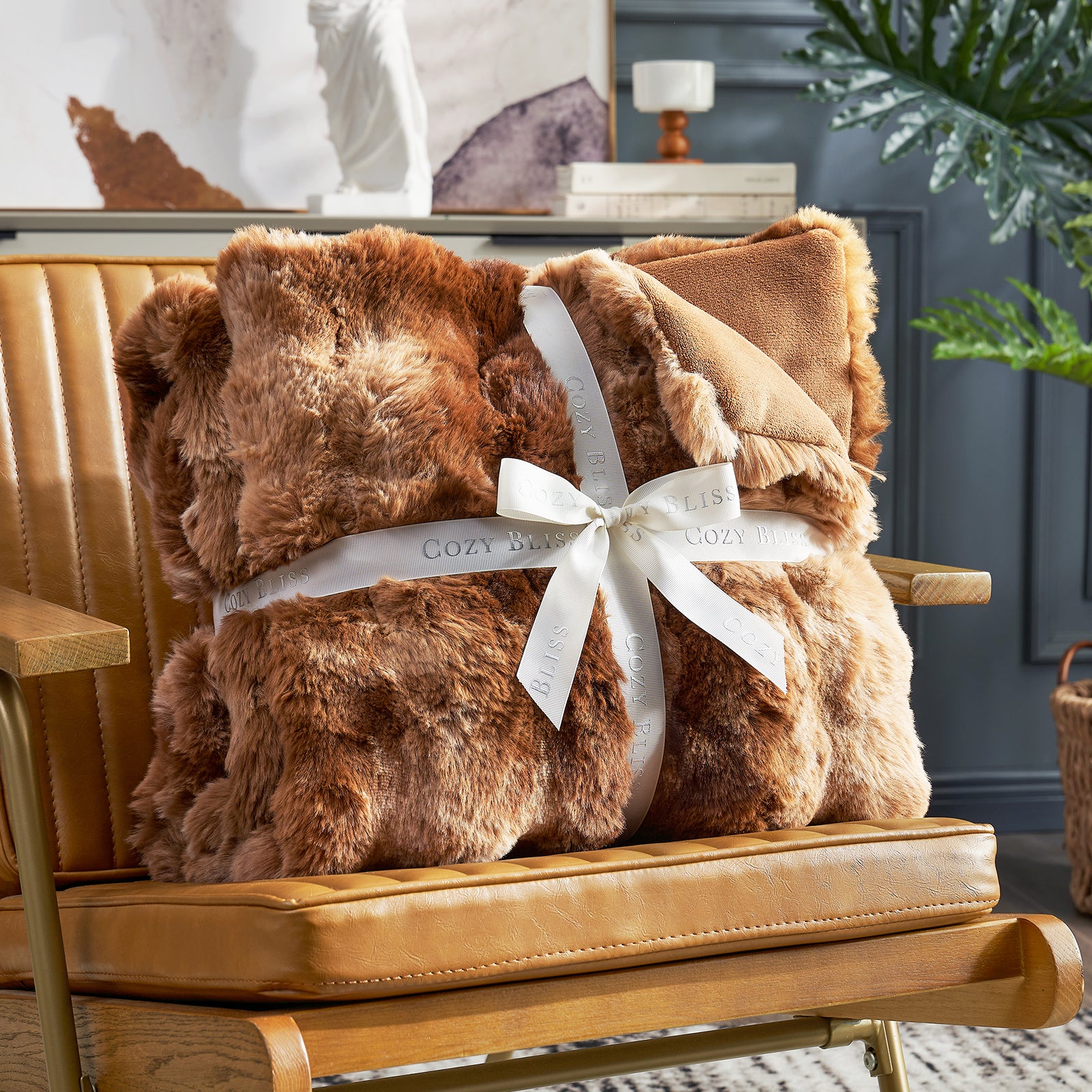 Cozy Bliss brown faux fur throw blanket on brown leather chair. Soft and cozy blanket. #color_Tie-dye Brown