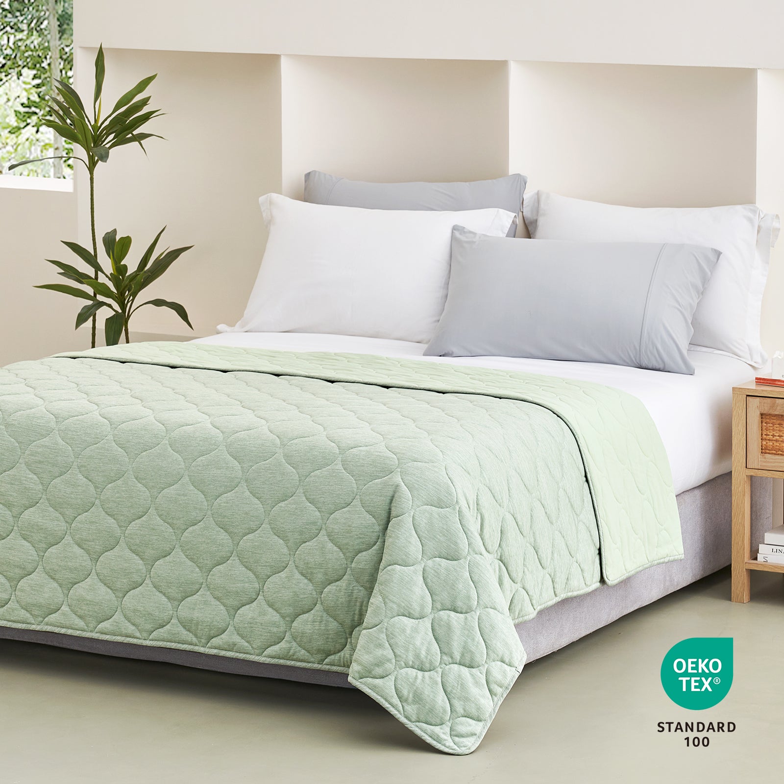 Sage green Cozy Bliss cooling blanket on a bed #color_Sage Green