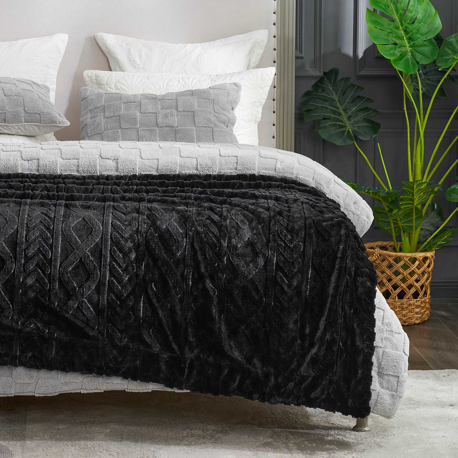 Cozy Bliss black cable knit faux fur throw blanket on bed, a soft and stylish home decor essential #color_Black