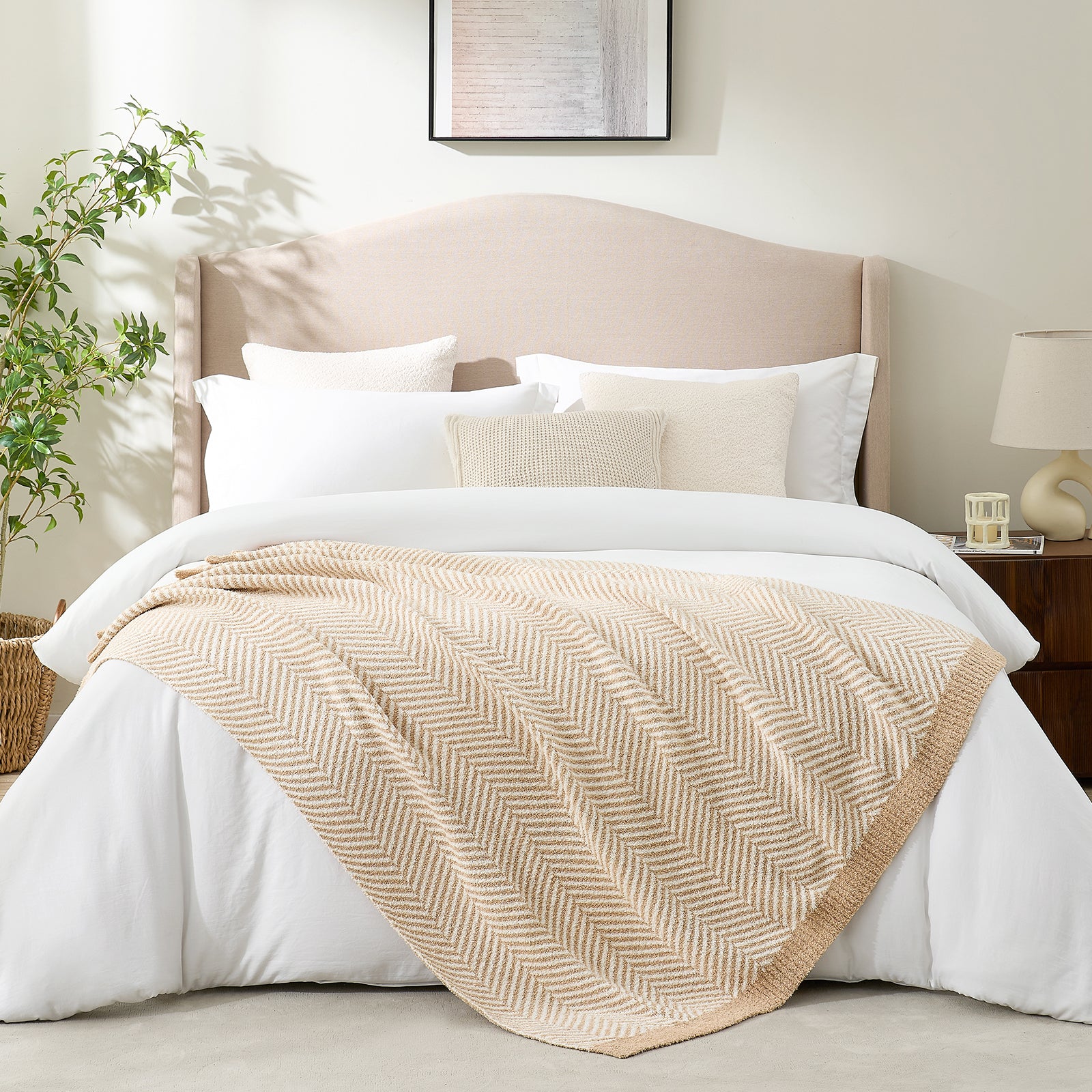 Reversible herringbone feather yarn knit throw blanket styled across a modern white bed #color_Beige