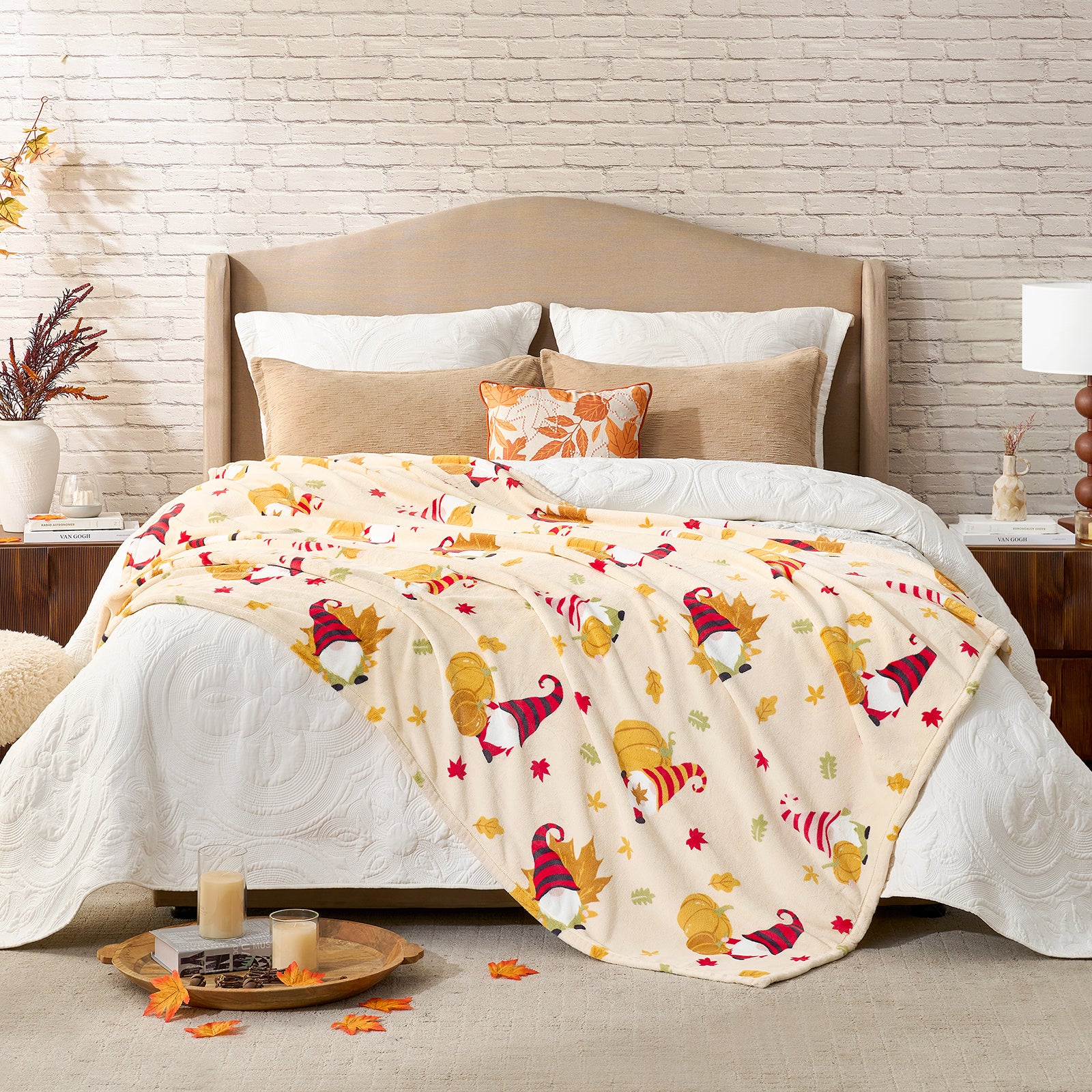 Bed with colorful gnome-patterned blanket and pillows in a cozy bedroom setting. #color_Pumpkin Gnome