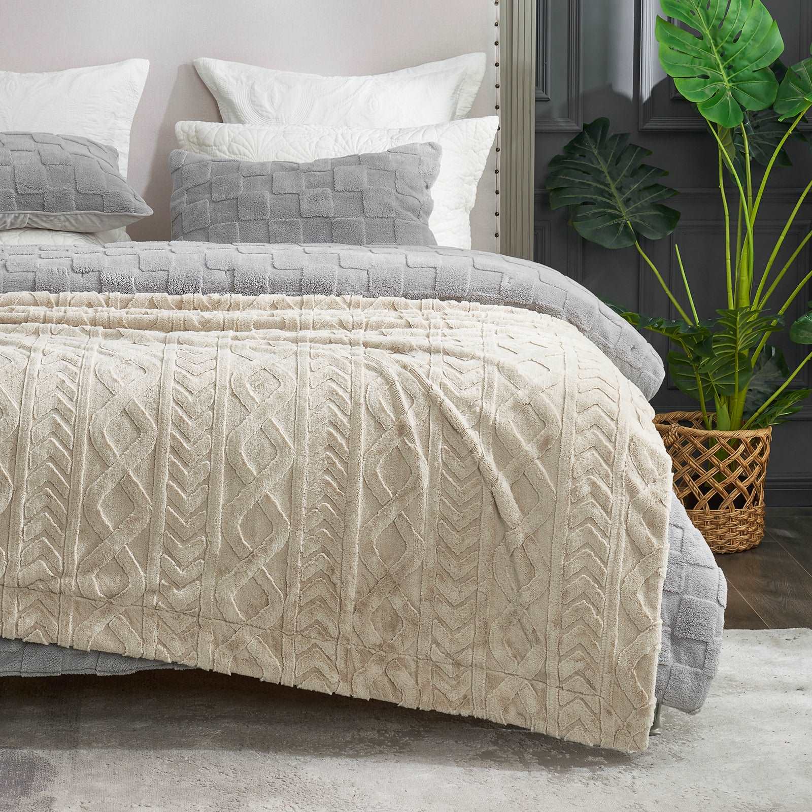 Cozy Bliss cream cable knit faux fur blanket on bed #color_Khaki