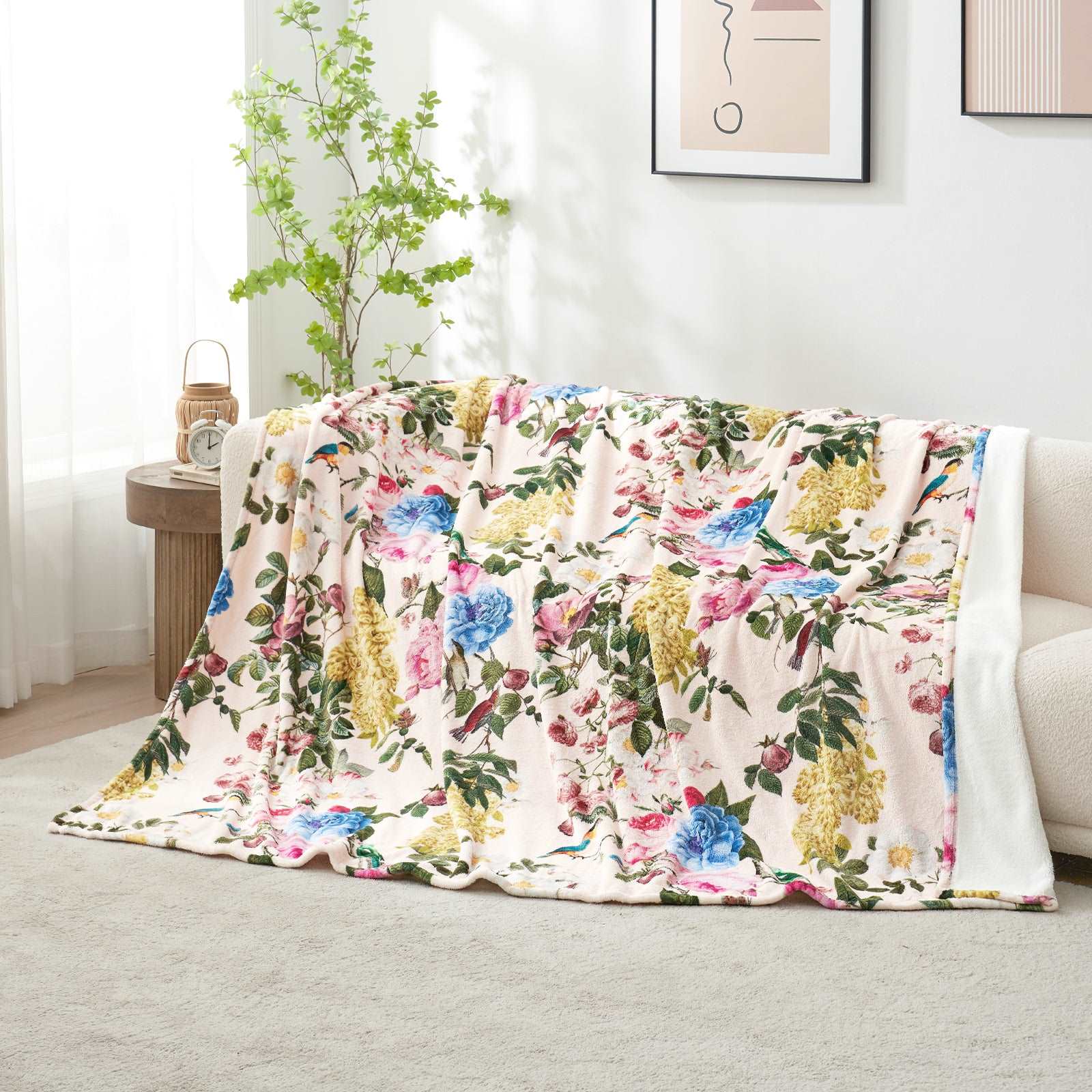 Floral Fleece Reversible Blanket on a sofa #color_Secret Garden