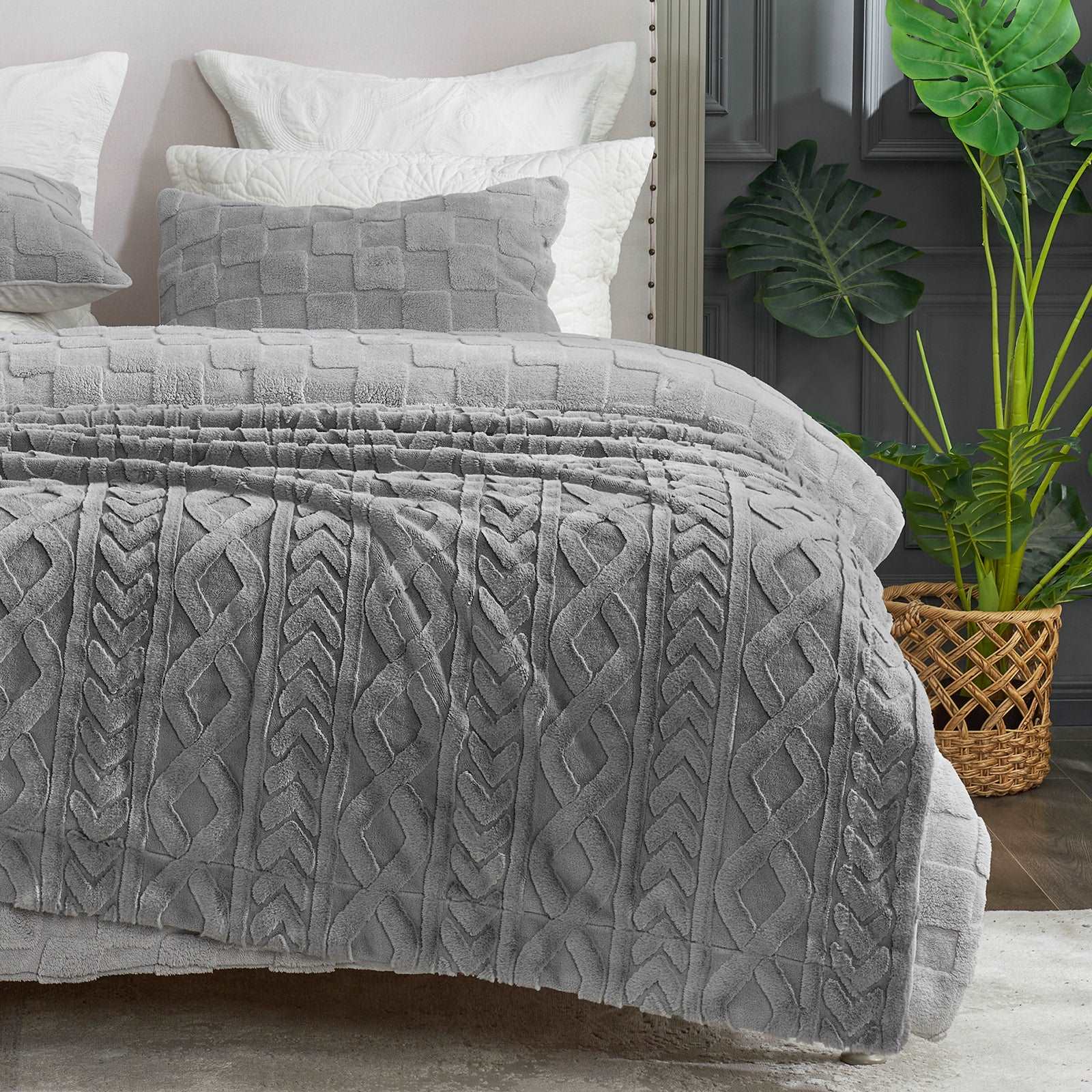 Gray cable knit faux fur cozy blanket on a bed, perfect for home decor and creating a comfortable space. #color_Grey