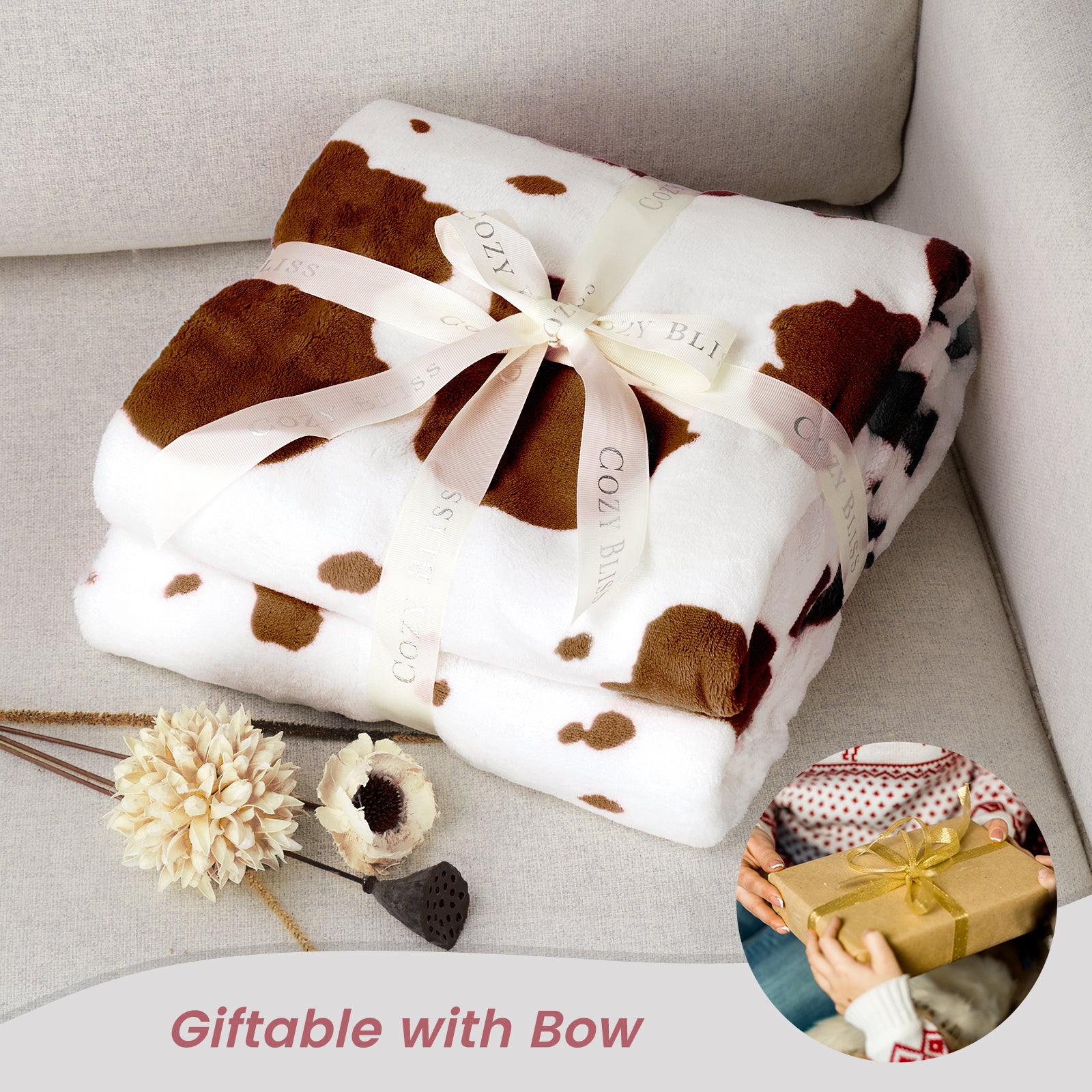 Cow print blanket with a bow on a light gray surface, with a small inset showing a person opening a gift. #color_Brown