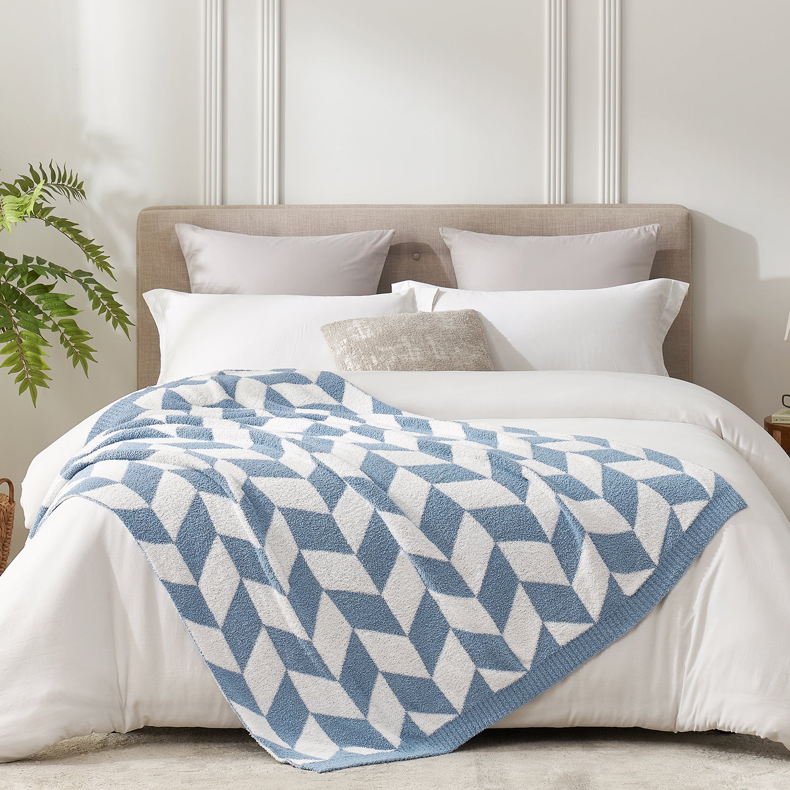 Chevron Feather Yarn Knit Throw Blanket in Blue styled on a bed, highlighting soft texture and modern chevron pattern in a bright bedroom setting. #color_Misty Blue