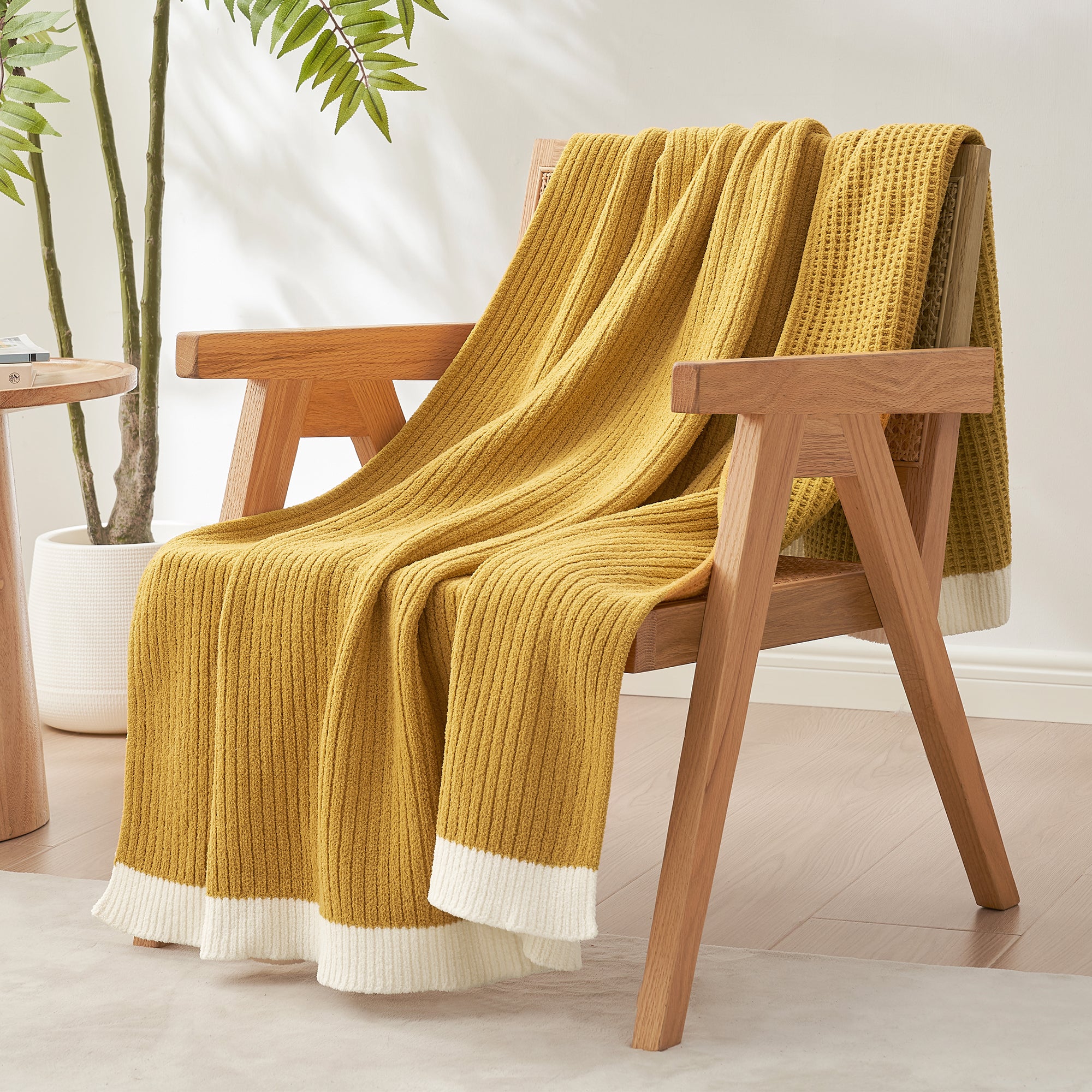 Chenille Waffle Knit Throw Blanket in Yellow draped over an armchair, creating a warm, inviting and stylish home atmosphere. #color_Yellow