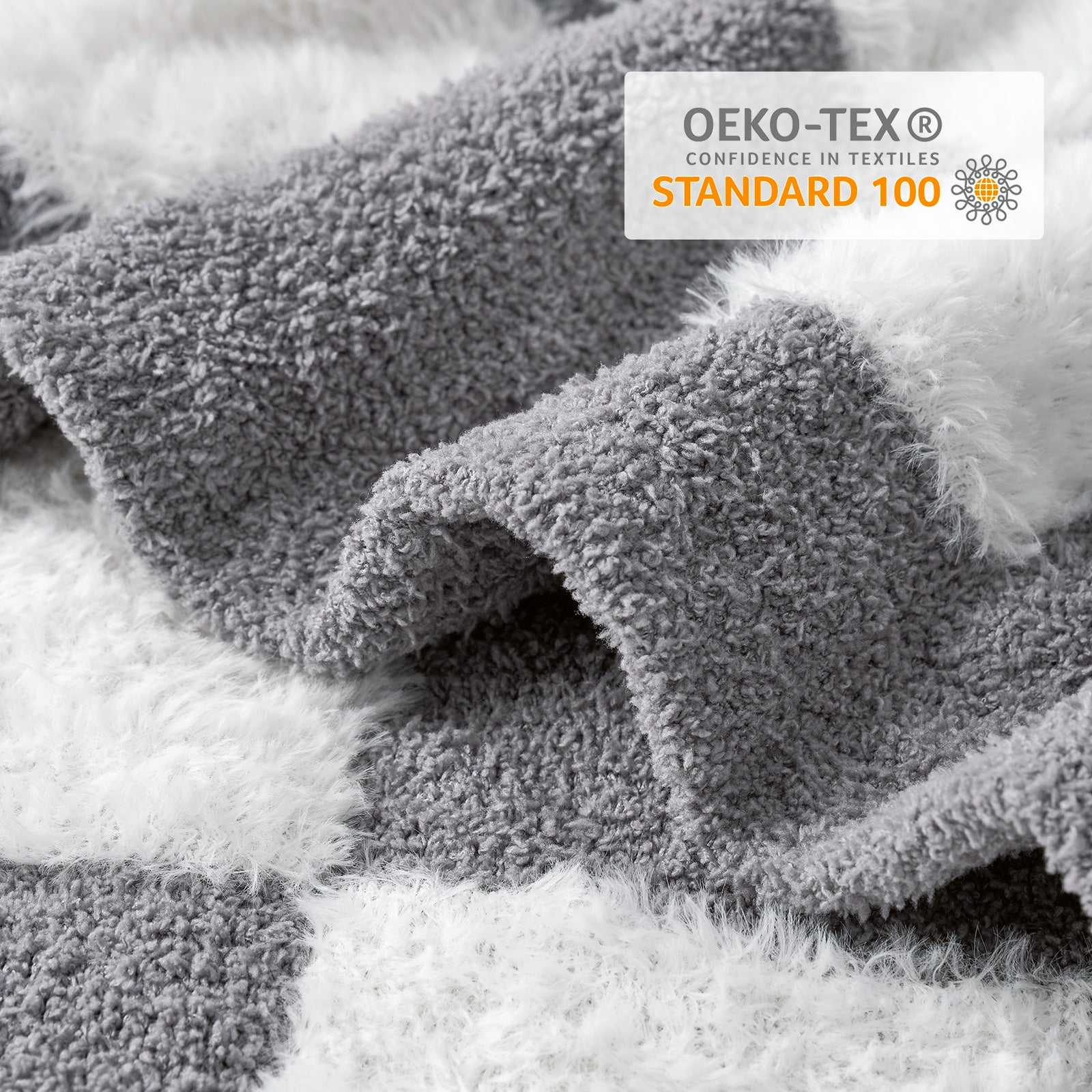 Close-up of Checkered Faux Fur Feather Yarn Throw Blanket in Grey & White showcasing plush texture and OEKO-TEX STANDARD 100 certification. #color_Grey & White