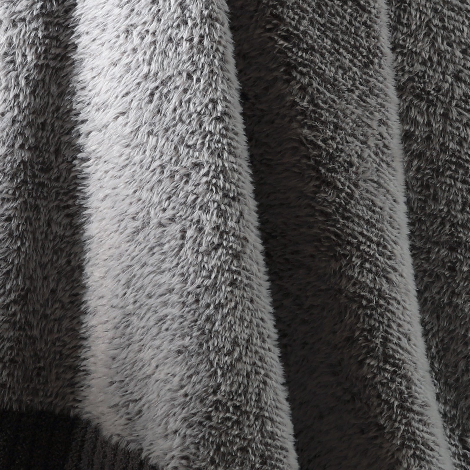 Macro close-up of faux mink fibers on Faux Mink Feather Knit Throw Blanket in Grey showcasing ultra soft and fluffy texture detail. #color_Grey