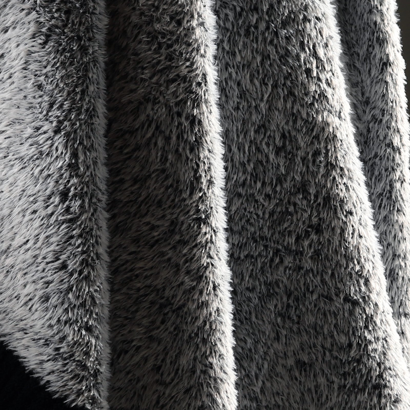 Macro close-up of faux mink fibers on Faux Mink Feather Knit Throw Blanket in Black showcasing ultra soft and fluffy texture detail. #color_Black