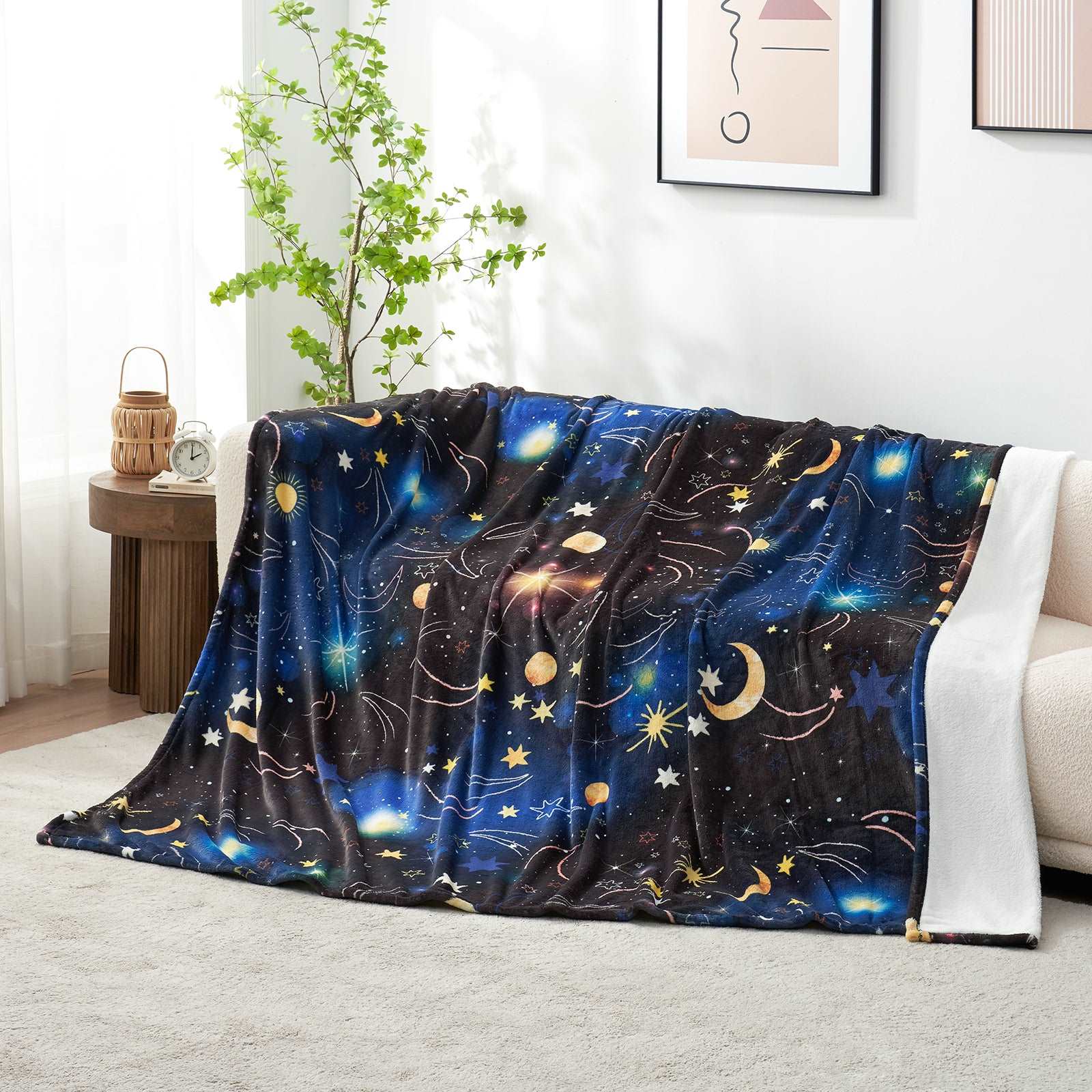Cozy Bliss Starry Sky Fleece Blanket draped on a sofa #color_Starry sky