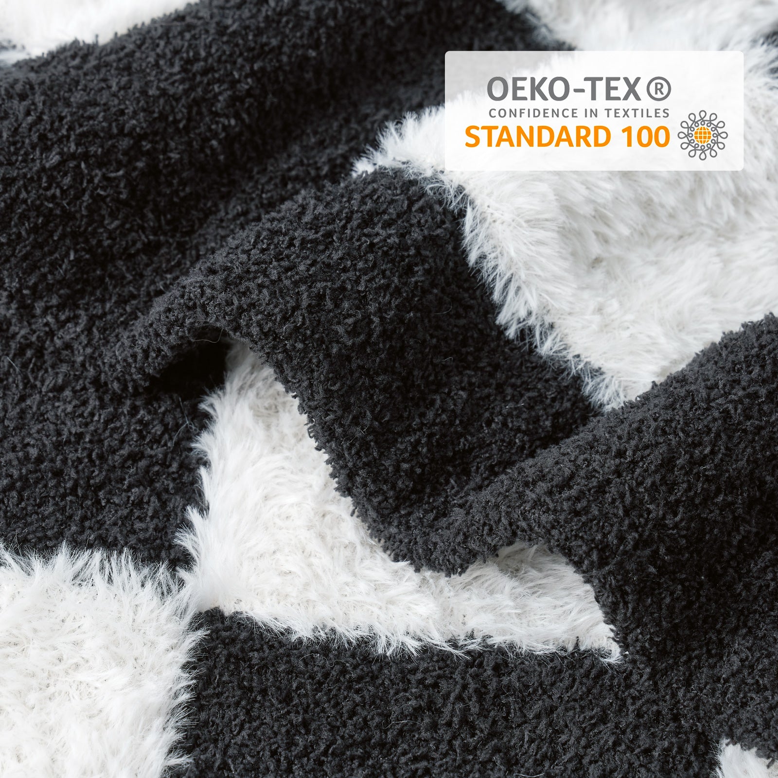 Close-up of Checkered Faux Fur Feather Yarn Throw Blanket in Black & White showcasing plush texture and OEKO-TEX STANDARD 100 certification. #color_Black & White