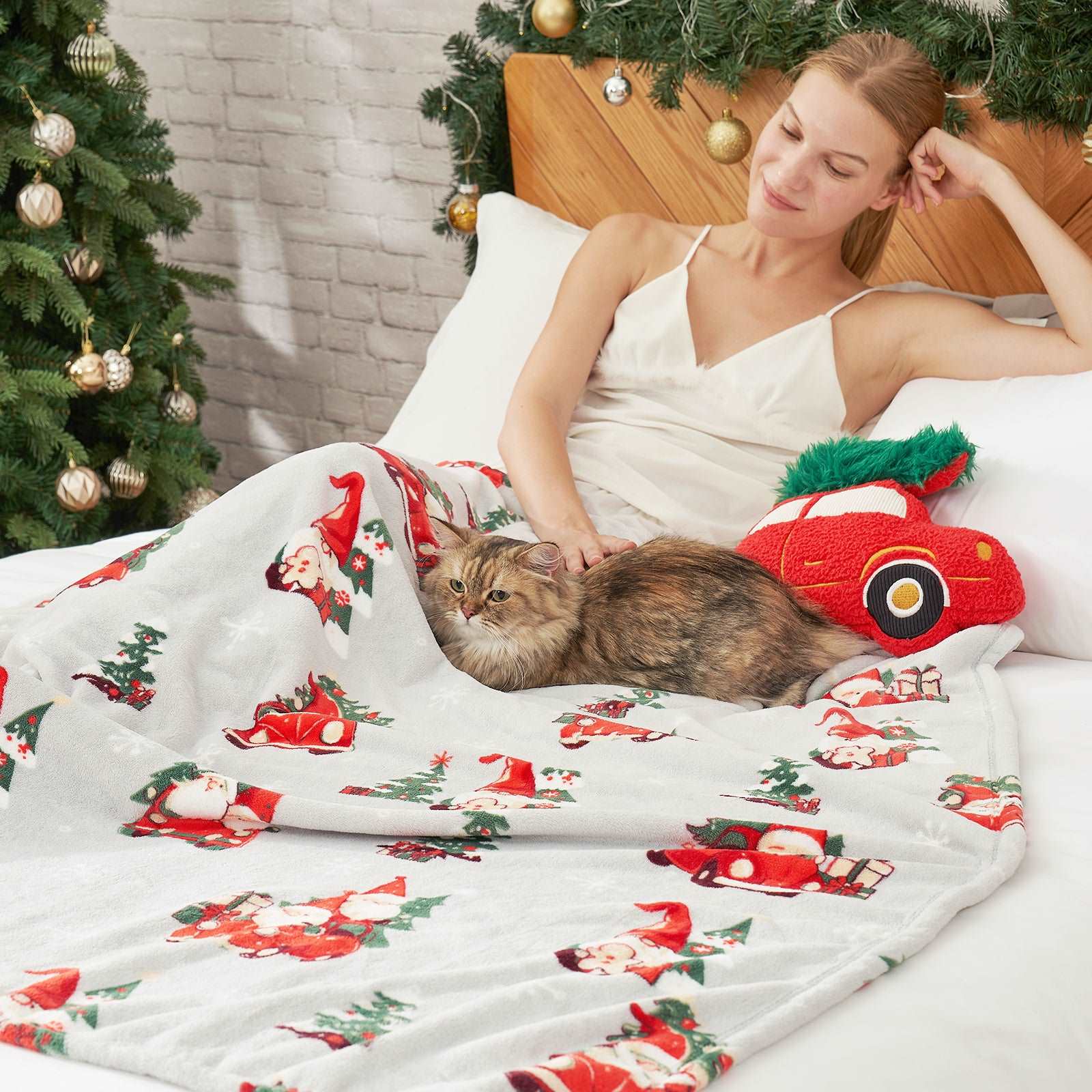 Woman relaxing with cat under Cozy Bliss Gnomes blanket, Christmas cozy vibes #color_ Gnome in Truck