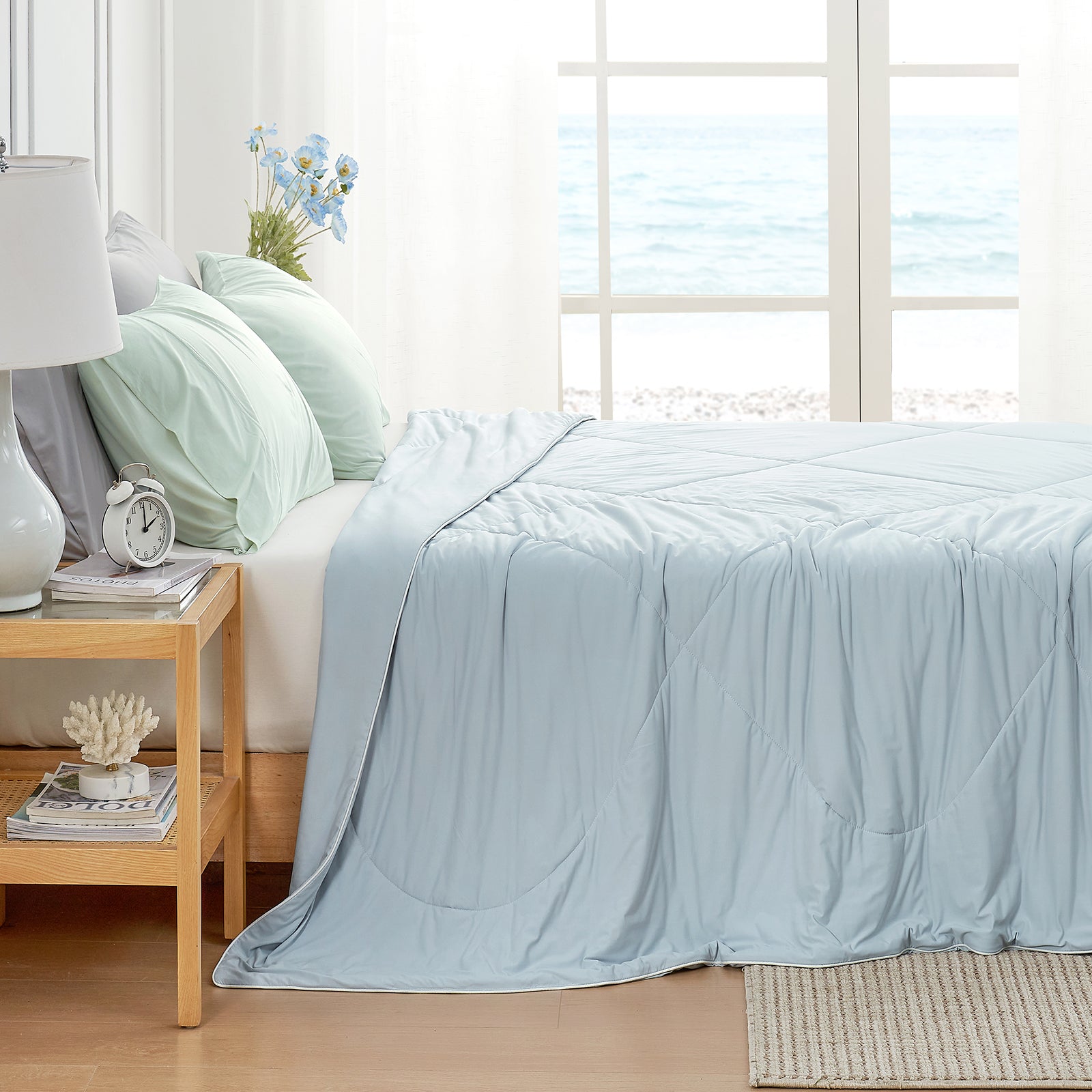 Cozy Bliss cooling blanketin bedroom setting, ocean view #Color_Blue