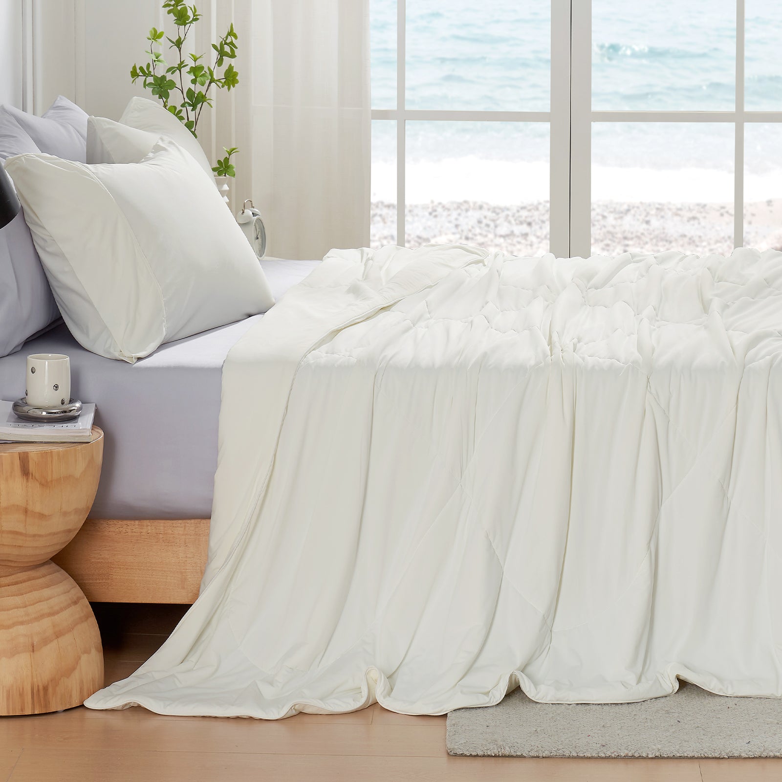 White cooling comforter on bed. Breathable, soft fabric for hot sleepers. #Color_Off White
