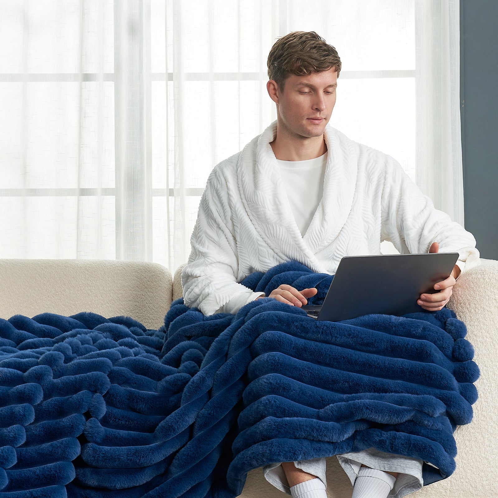 Man relaxing under a blue striped faux fur blanket, Cozy Bliss, for cozy warmth #color_Navy Blue