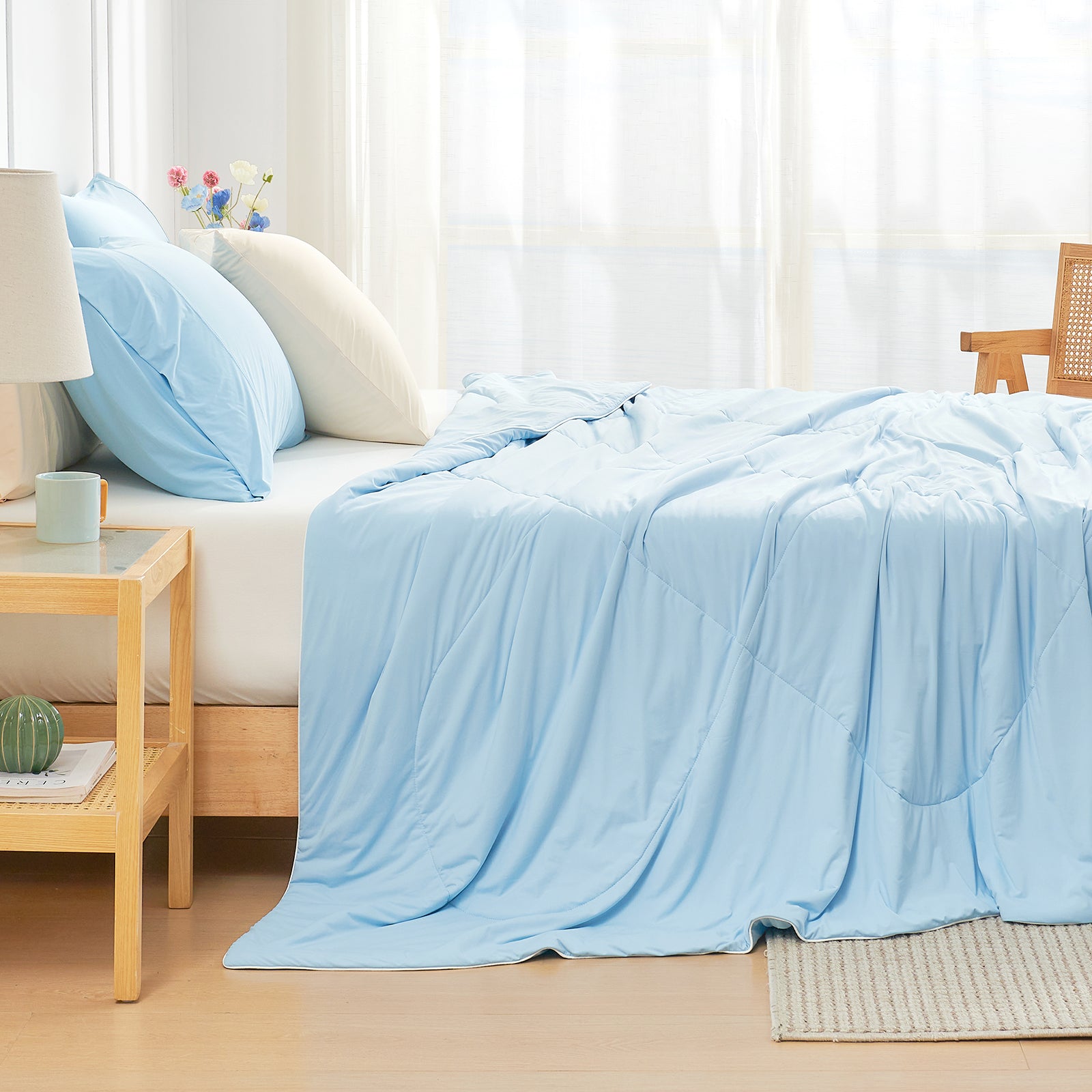 Cozy Bliss light blue cooling comforter on bed, breathable bedding for hot sleepers #Color_Sky Blue