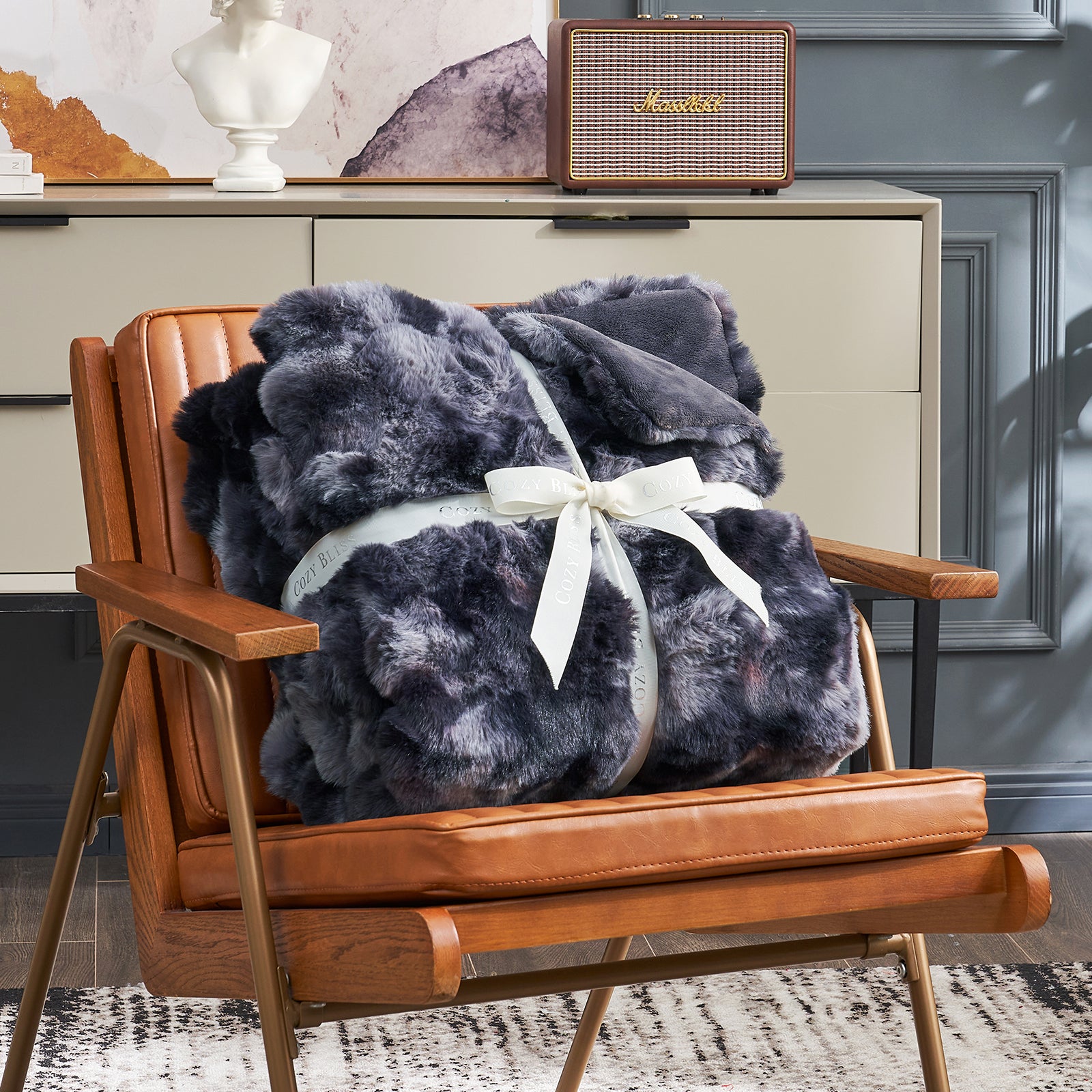 Cozy Bliss gray tie-dye faux fur throw blanket on a brown chair #color_Tie-dye Black