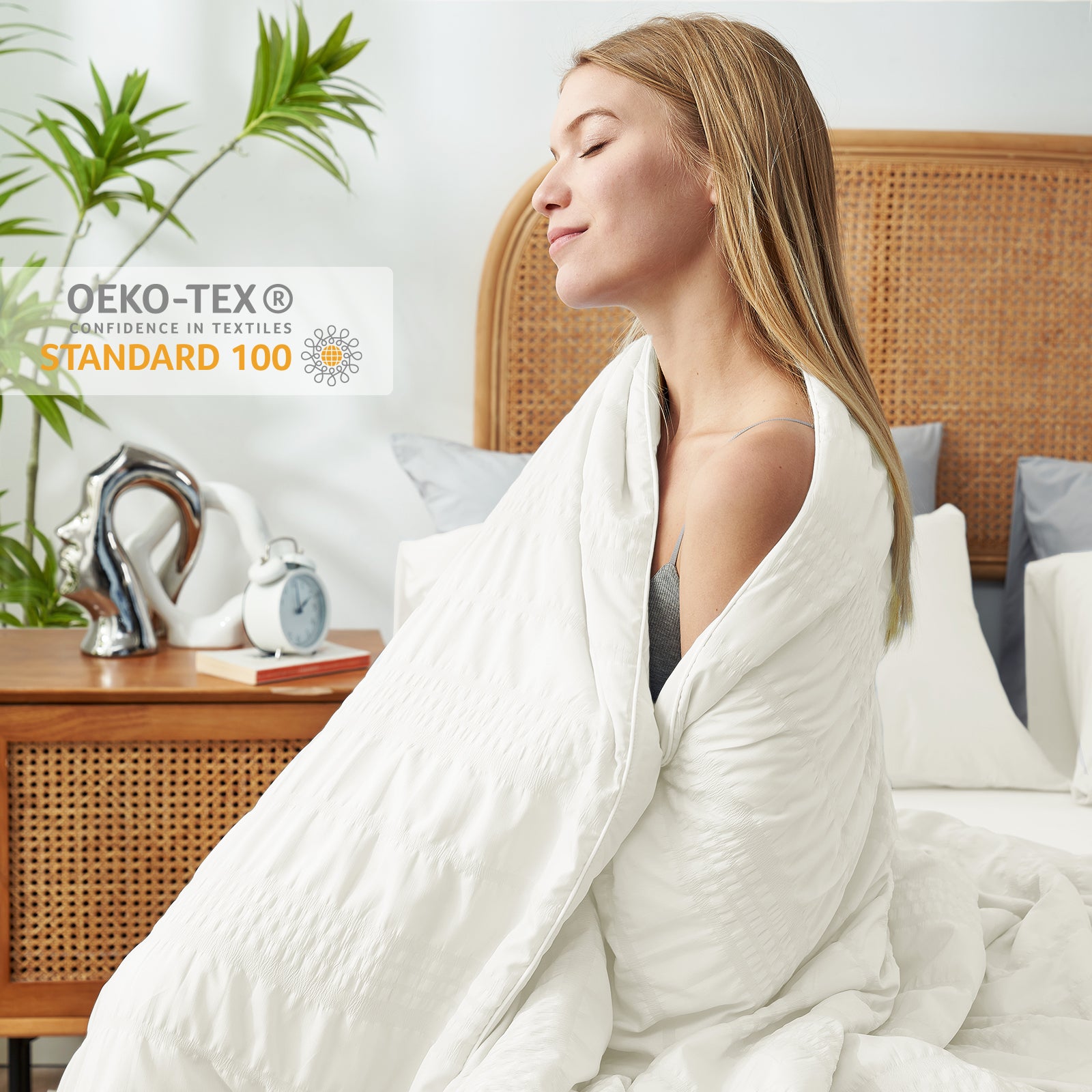 Woman wrapped in a white, textured cooling comforter, Oeko-Tex certified, on bed, promoting cozy sleep #color_Cream White
