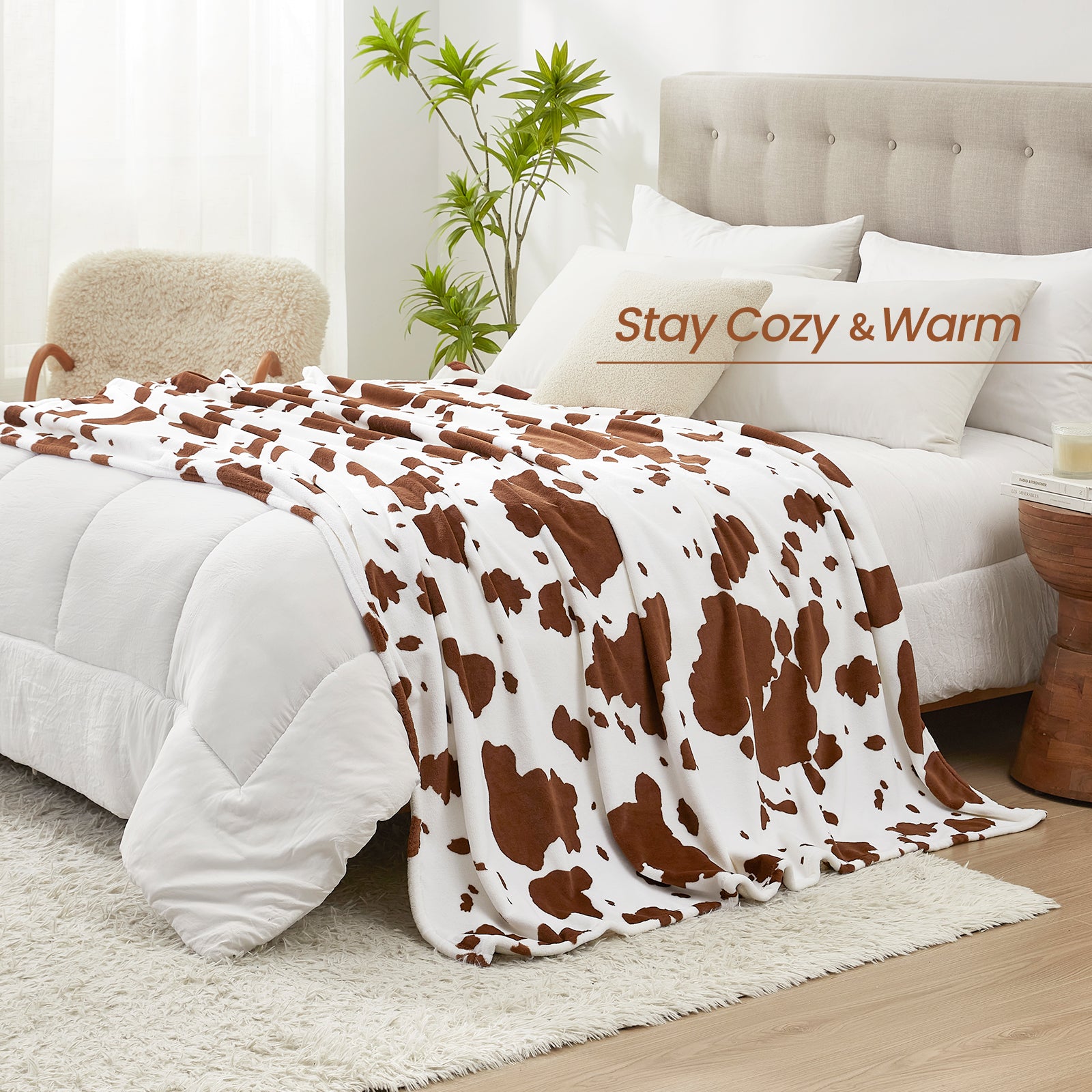 Bed with cow print blanket and 'Stay Cozy & Warm' text in a bedroom setting. #color_Brown
