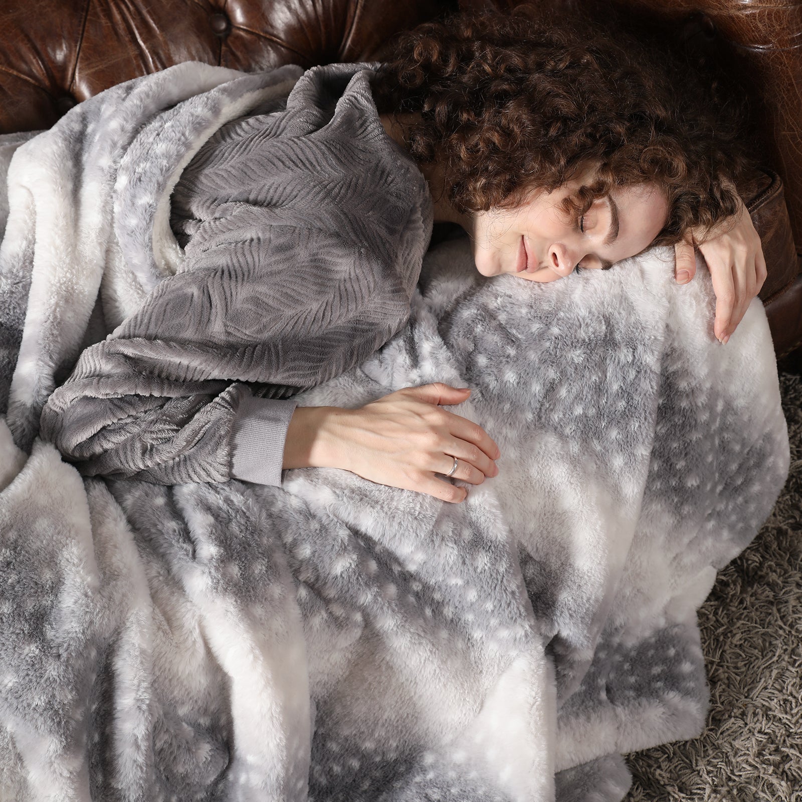 Person wrapped in a gray blanket on a couch #color_Grey