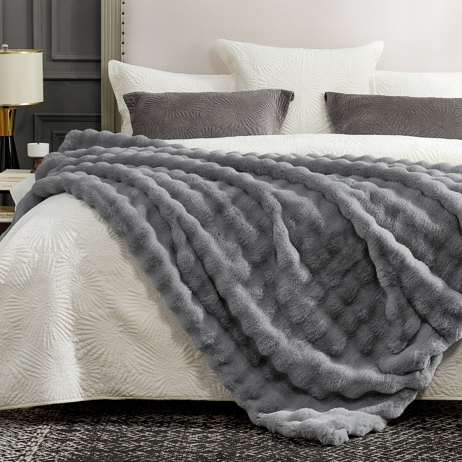 Gray textured blanket draped over a bed in a bedroom setting #color_Light Grey
