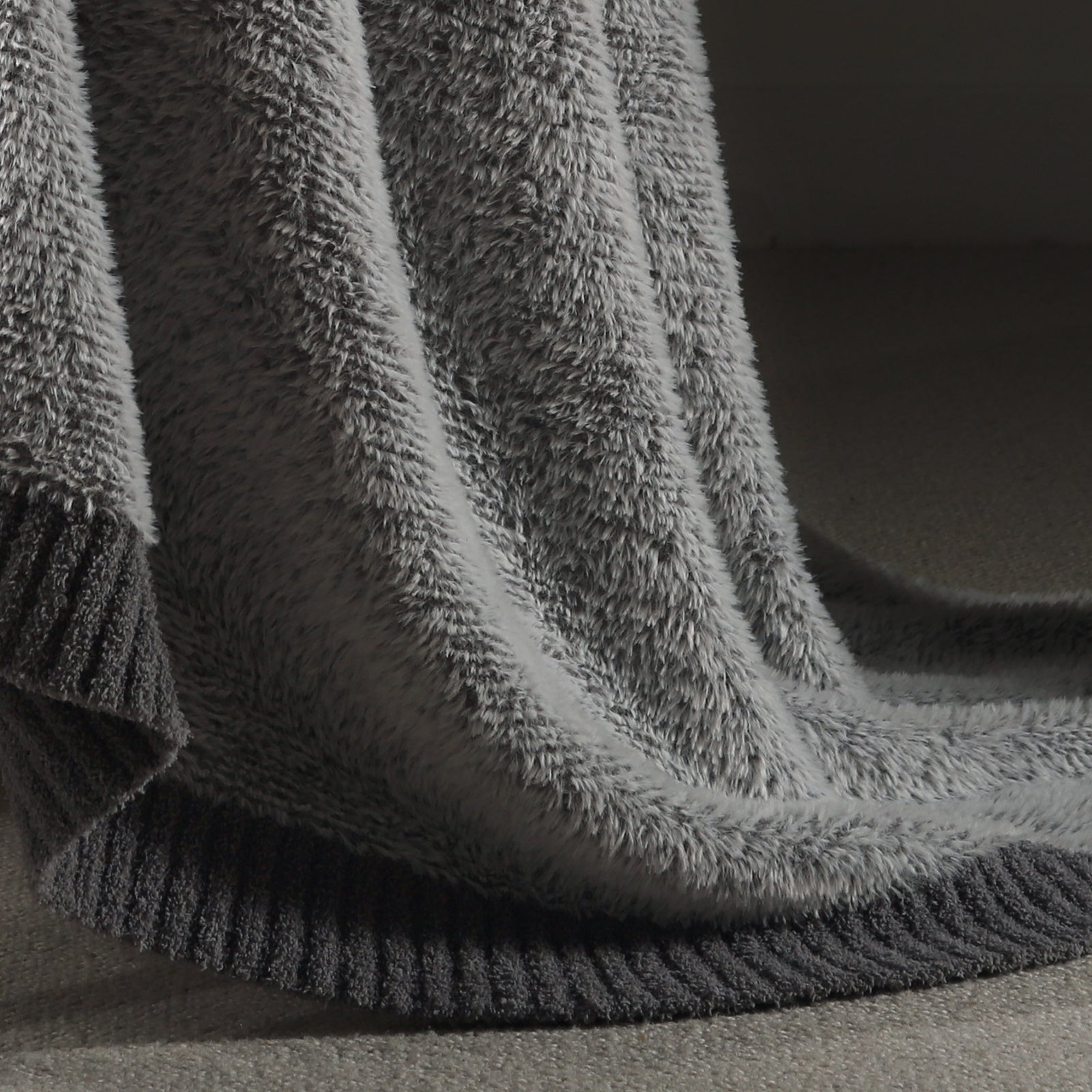 Close-up of faux mink texture on Faux Mink Feather Knit Throw Blanket in Grey highlighting soft plush fibers and cozy feel. #color_Grey