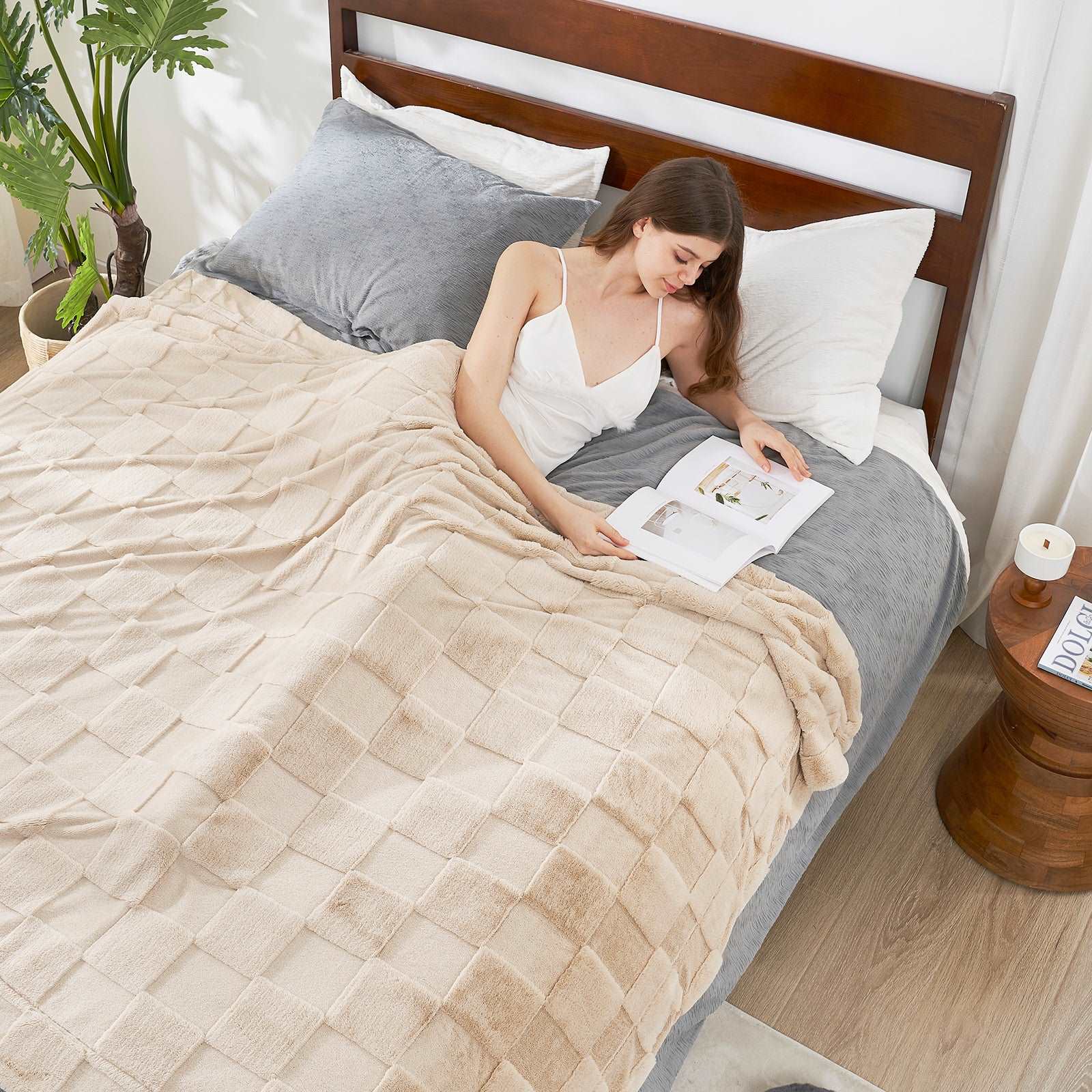 Woman reading under cozy cream checkboard faux fur blanket #color_Beige