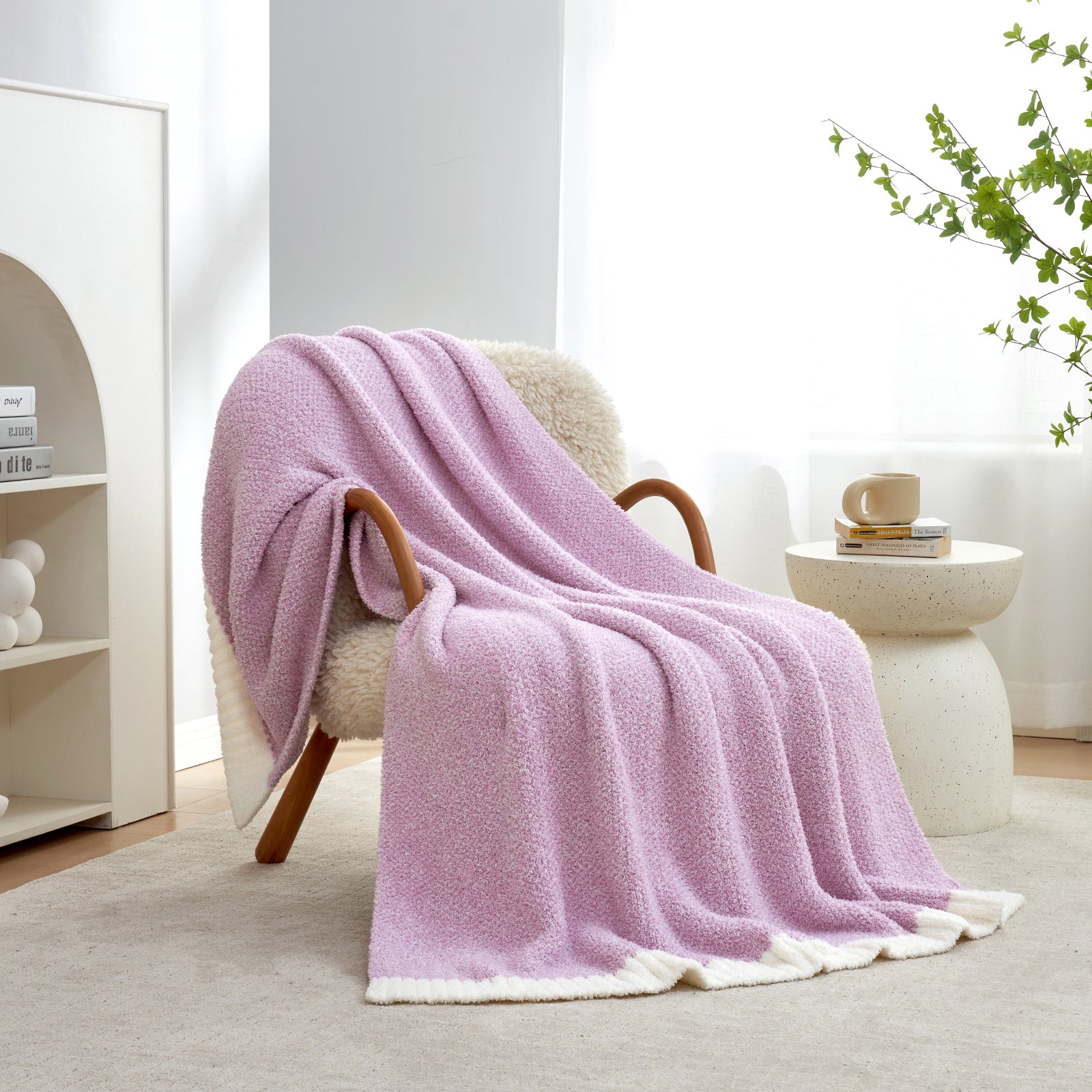 Heather Feather Yarn Throw Blanket in Purple draped over an armchair, creating a warm atmosphere. #color_Purple